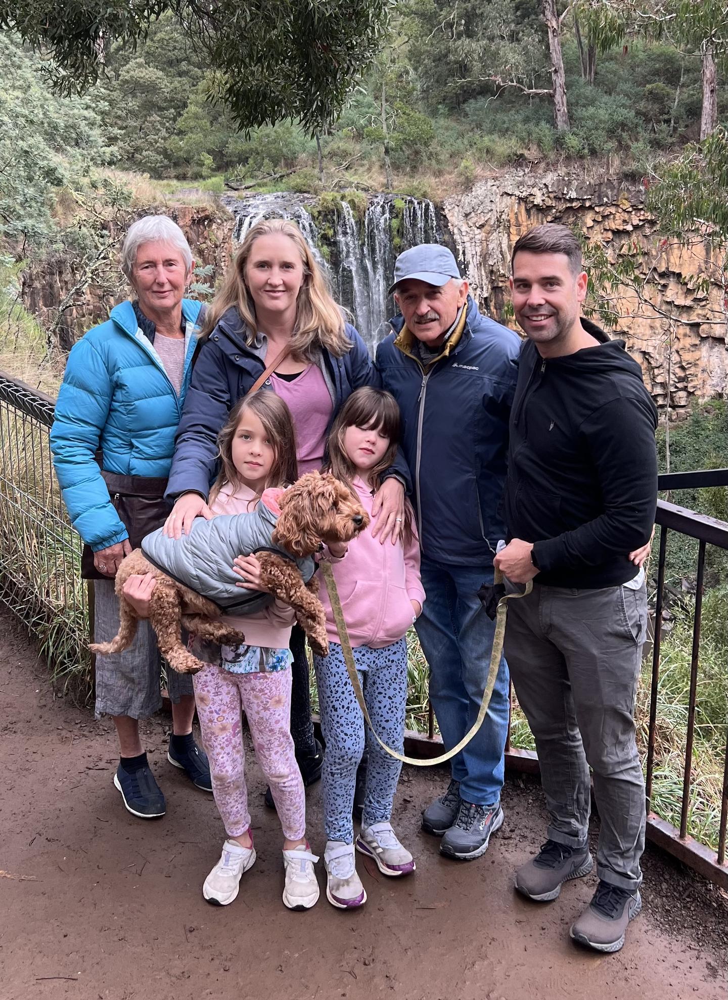 Dr Logan McLennan and his family in Australia in 2023. Back row from left: Robin McLennan, daughter Ana Adams, Dr McLennan, Jon Adams, and, in front, Isla (holding dog Ruby) and Holly Adams.