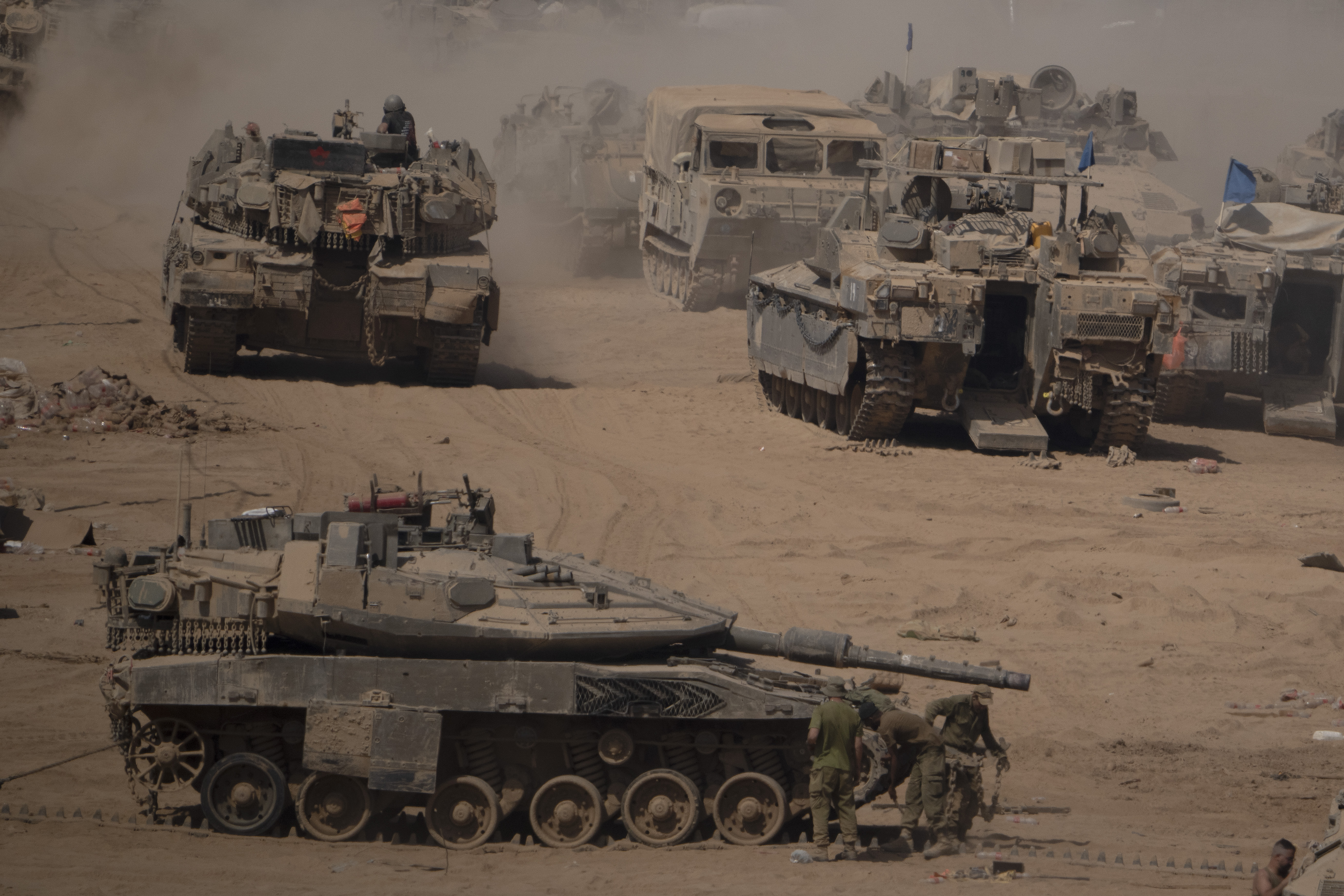 Israeli soldiers work on a tank in a staging area near the Israeli-Gaza border in southern Israel on Monday, June 3. Photo / AP
