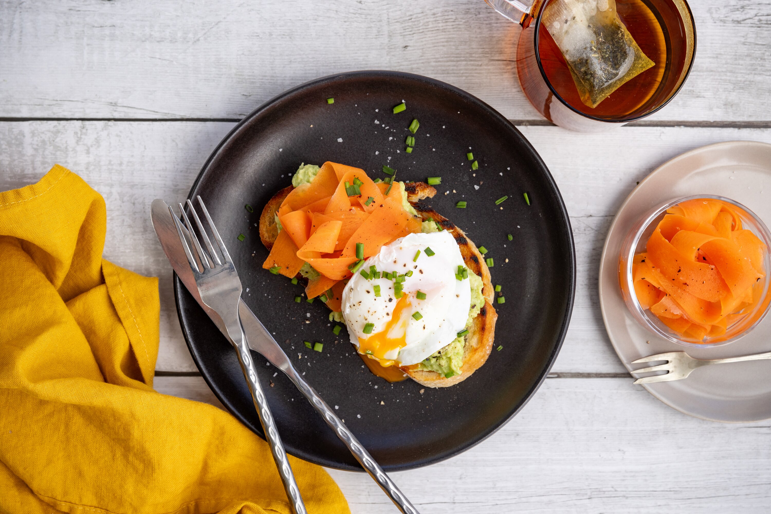 Pickled carrot and avocado on toast with poached egg. Photo / Babiche Martens