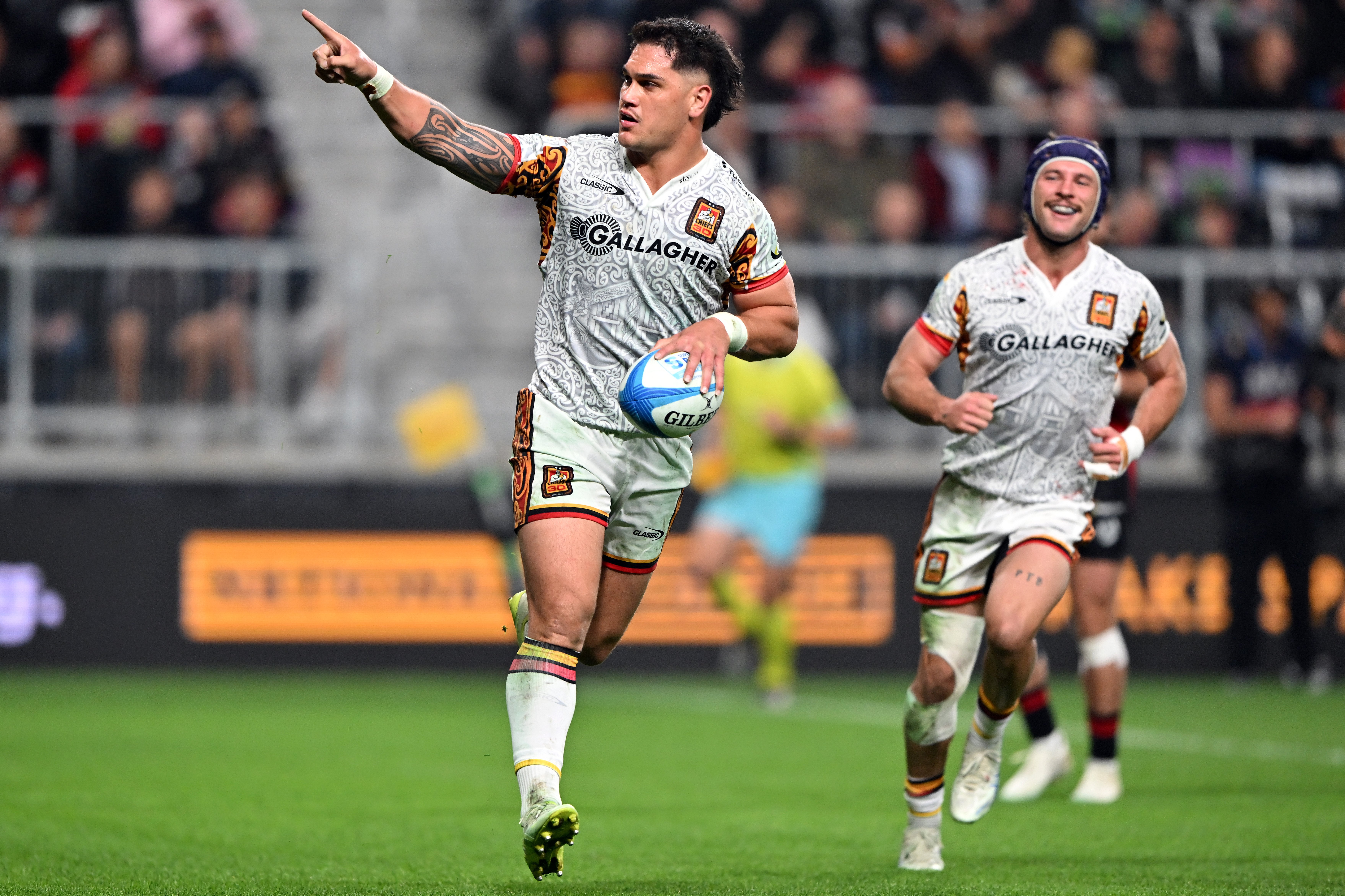 Chiefs midfielder Quinn Tupaea celebrates a try against the Crusaders. Photo / Getty Images