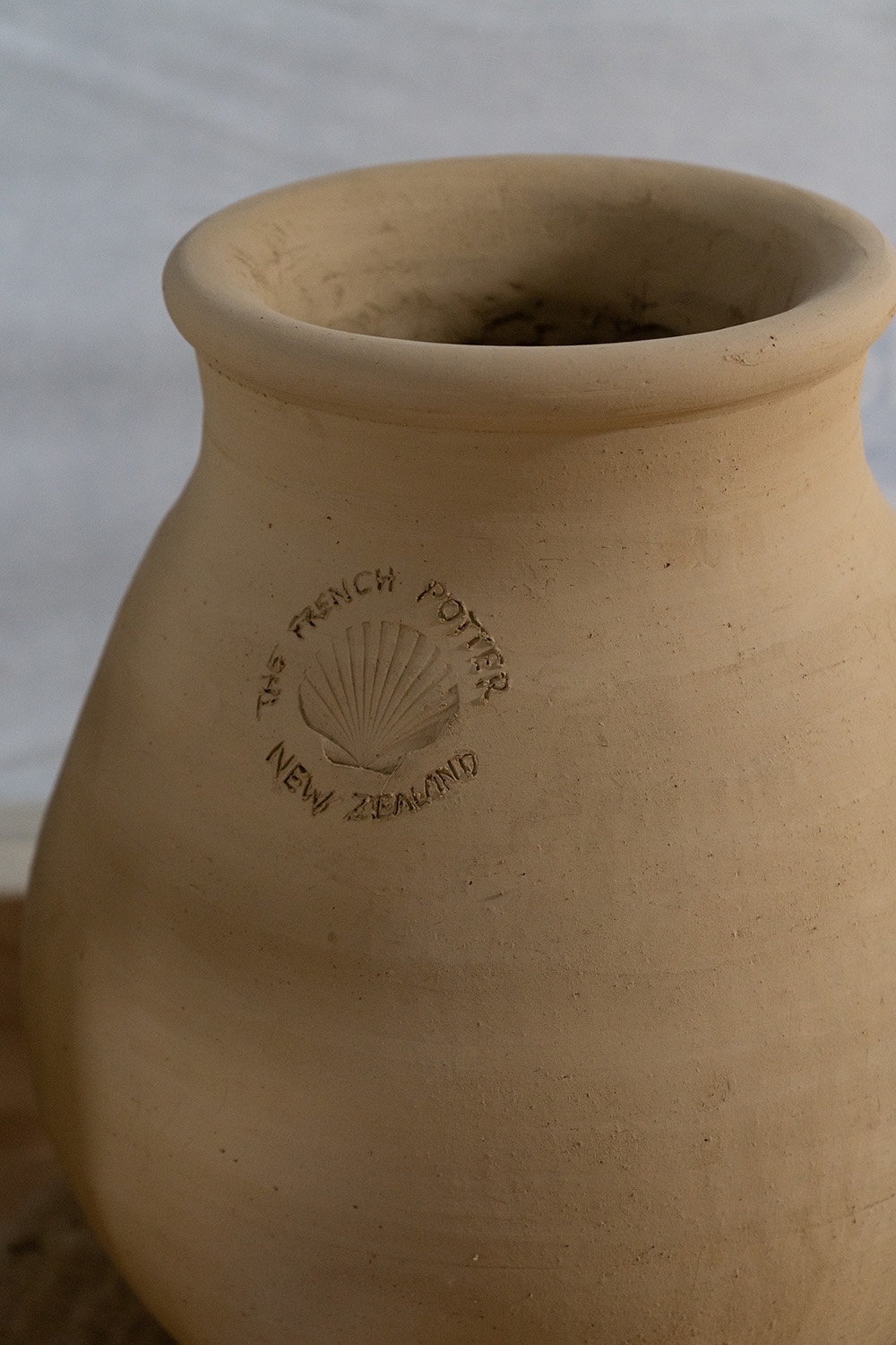 For his logo, Yannick handwrites The French Potter New Zealand around the imprint of a Bluff scallop shell. Here, it’s stamped into a pot pre-firing. Photo / Hyuma Kaneko