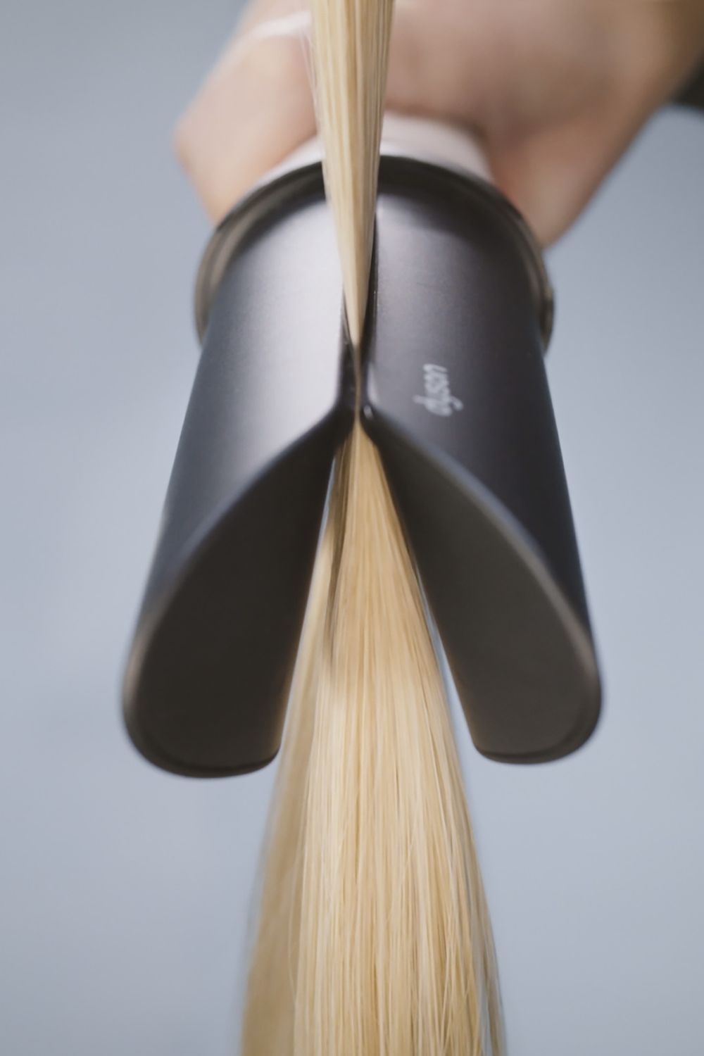The Air Smooth attachment uses haptics to clamp down on to hair and release after a full pass, making easy work of sectioning your style. Photo / Supplied