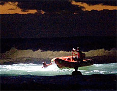 A rescue boat with the help of a helicopter spotlight searches for Sonny Fai hours after he went missing. Photo / Dean Purcell