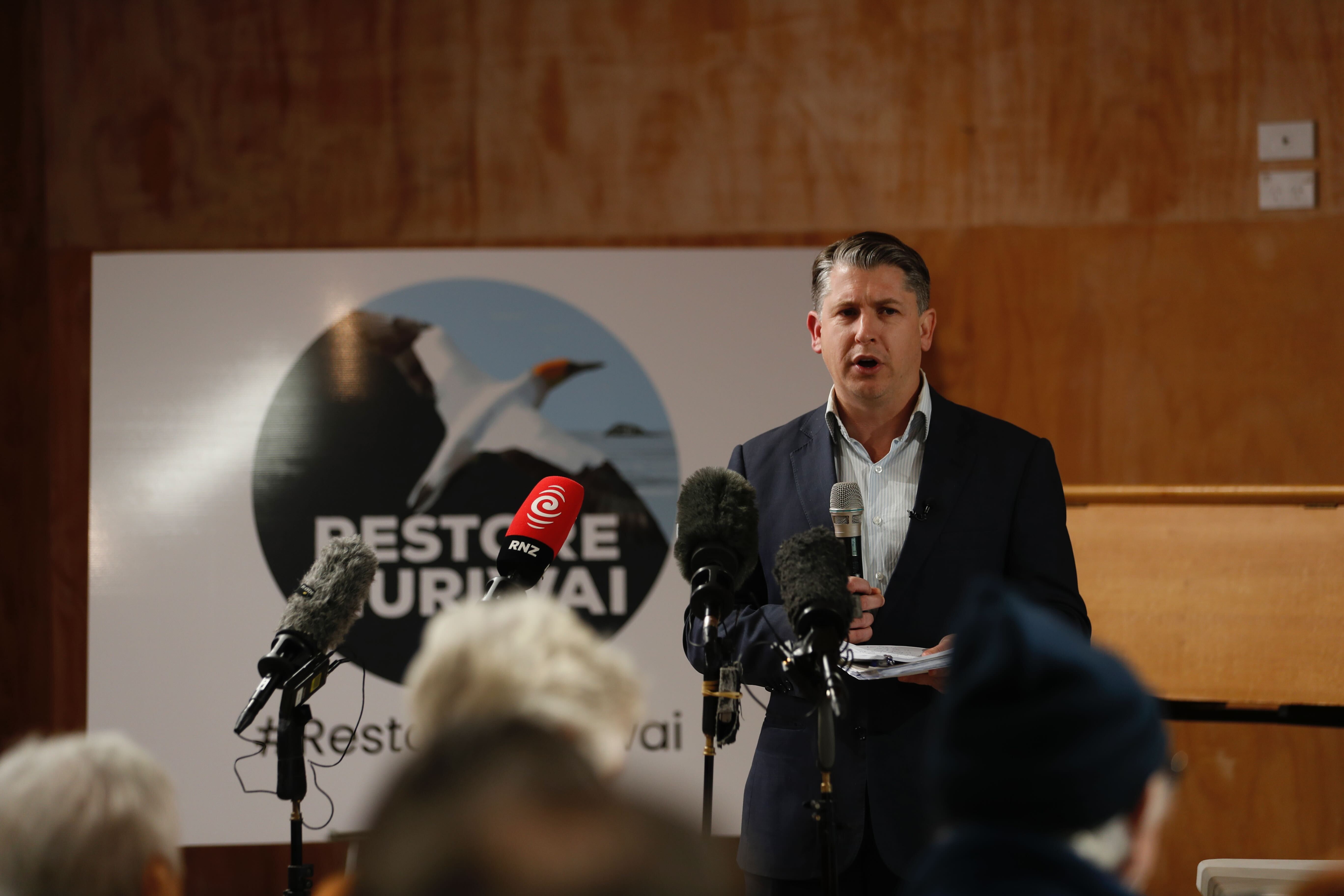 Minister for Auckland Michael Wood address Muriwai residents on the cyclone recovery effort. Photo / Dean Purcell
