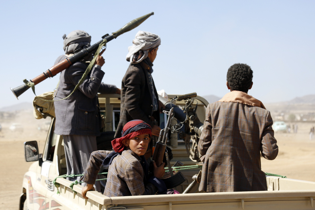 Houthi fighters and tribesmen stage a rally against the US and British strikes on Houthi-run military sites near Yemen. Photo / AP