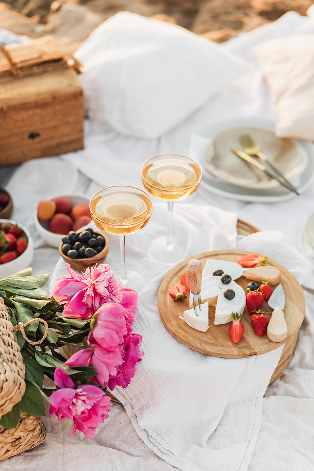 Every picnic needs a juicy summer wine and a plate of cheese. Photo / Getty Images