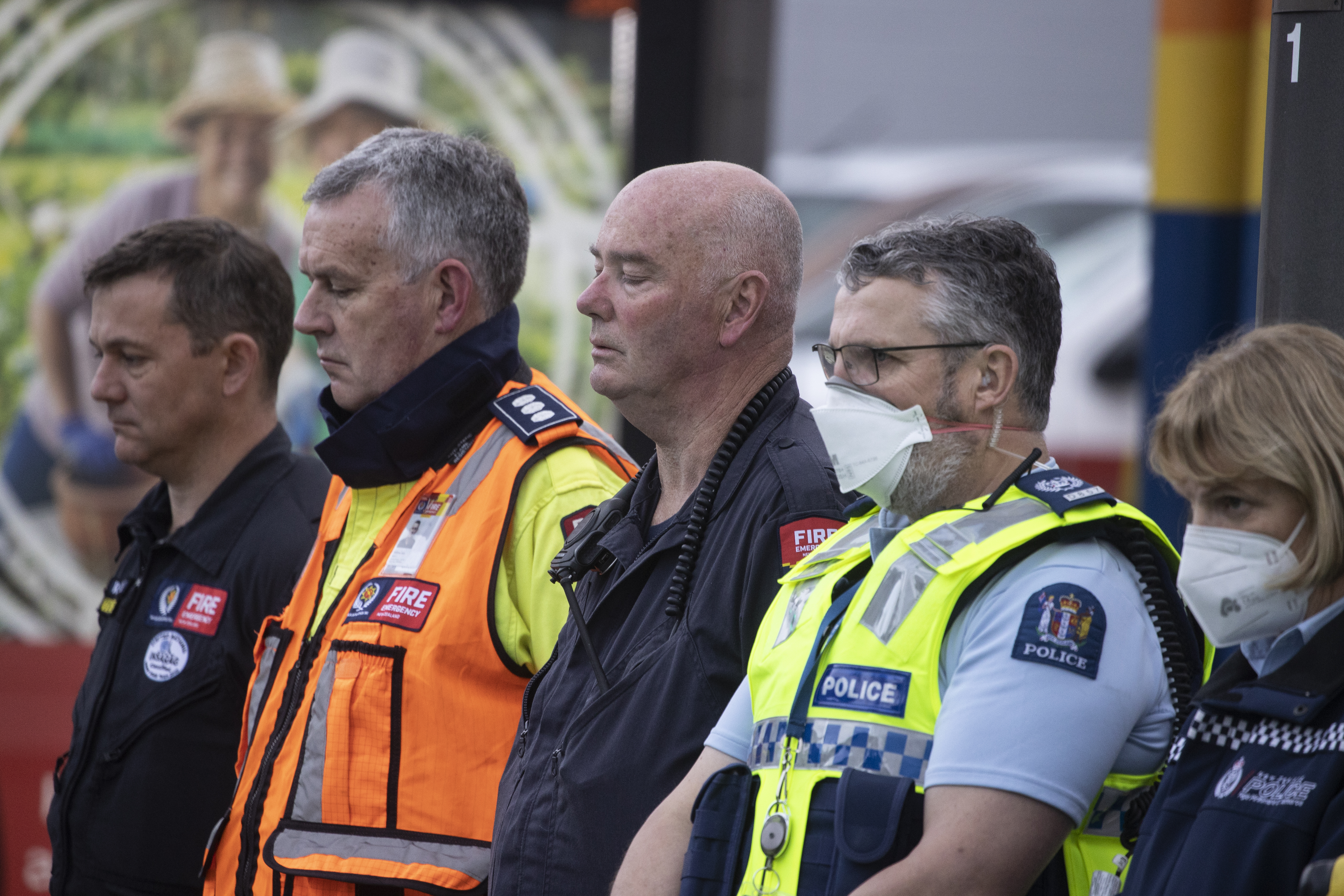 Emergency services formed a guard of honour along a footpath near the hostel as they awaited the first body to be removed from Loafers Lodge. Photo / George Heard