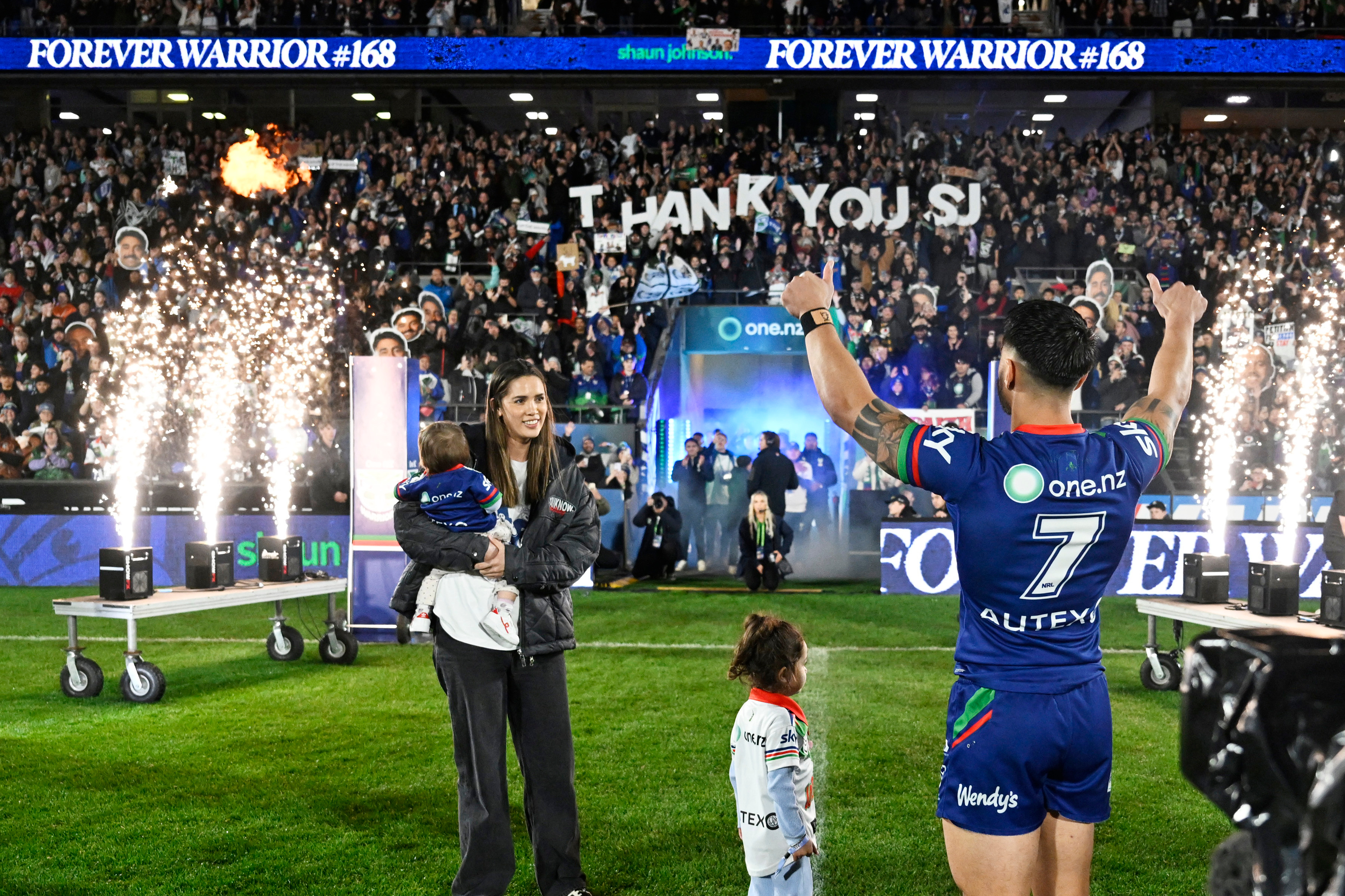 Warriors player Shaun Johnson and his family walk out for his last home game. Photo / Photosport
