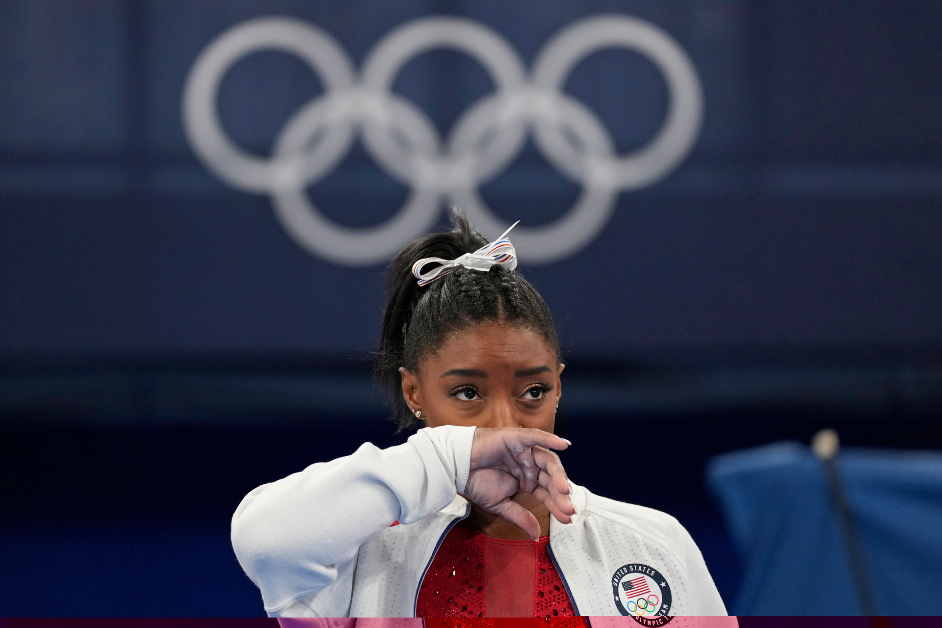 Simone Biles, of the United States, watches gymnasts perform after pulling out of the Tokyo Olympics. Photo / AP