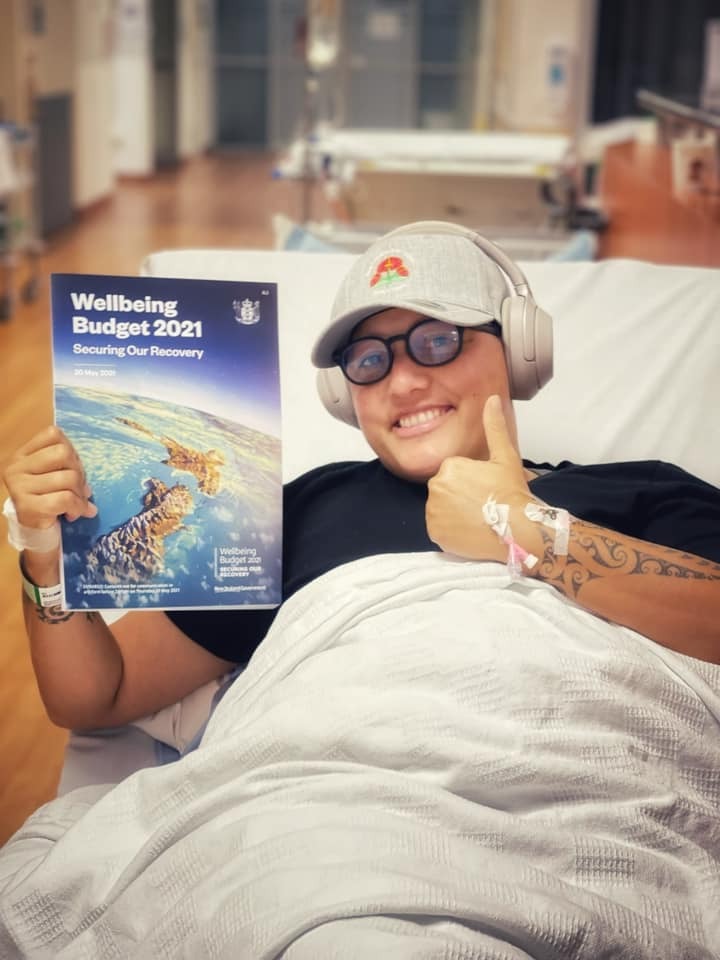 One of Kiritapu Allan's Facebook posts, reading the Budget with her headphones on.