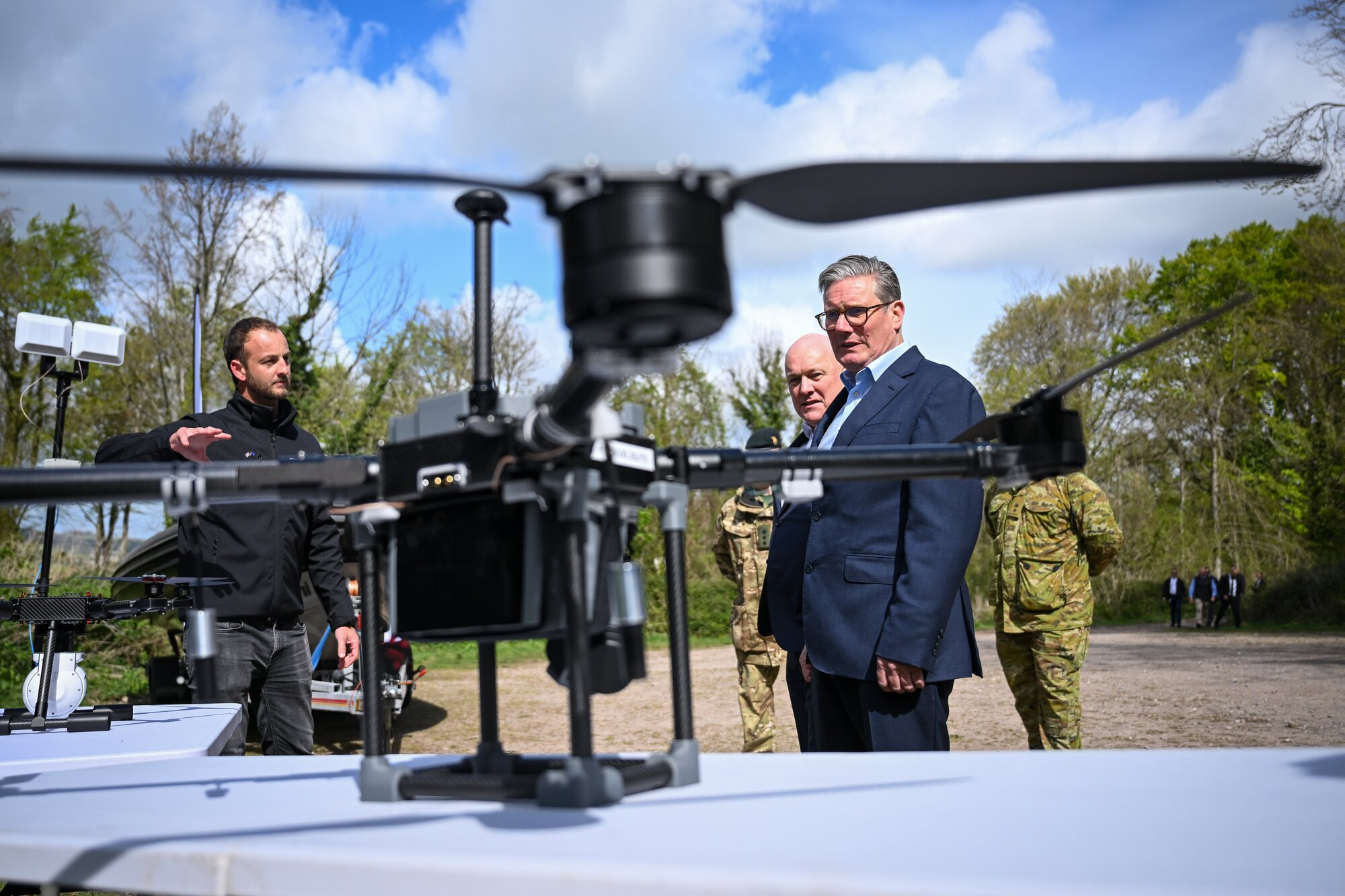 Syos founder Sam Vye demonstrates one of his company's drones to UK Prime Minister Sir Keir Starmer (front) and New Zealand Prime Minister Christopher Luxon during an April 22 visit to a military base training Ukrainian troops in the west of England. Photo / Getty Images