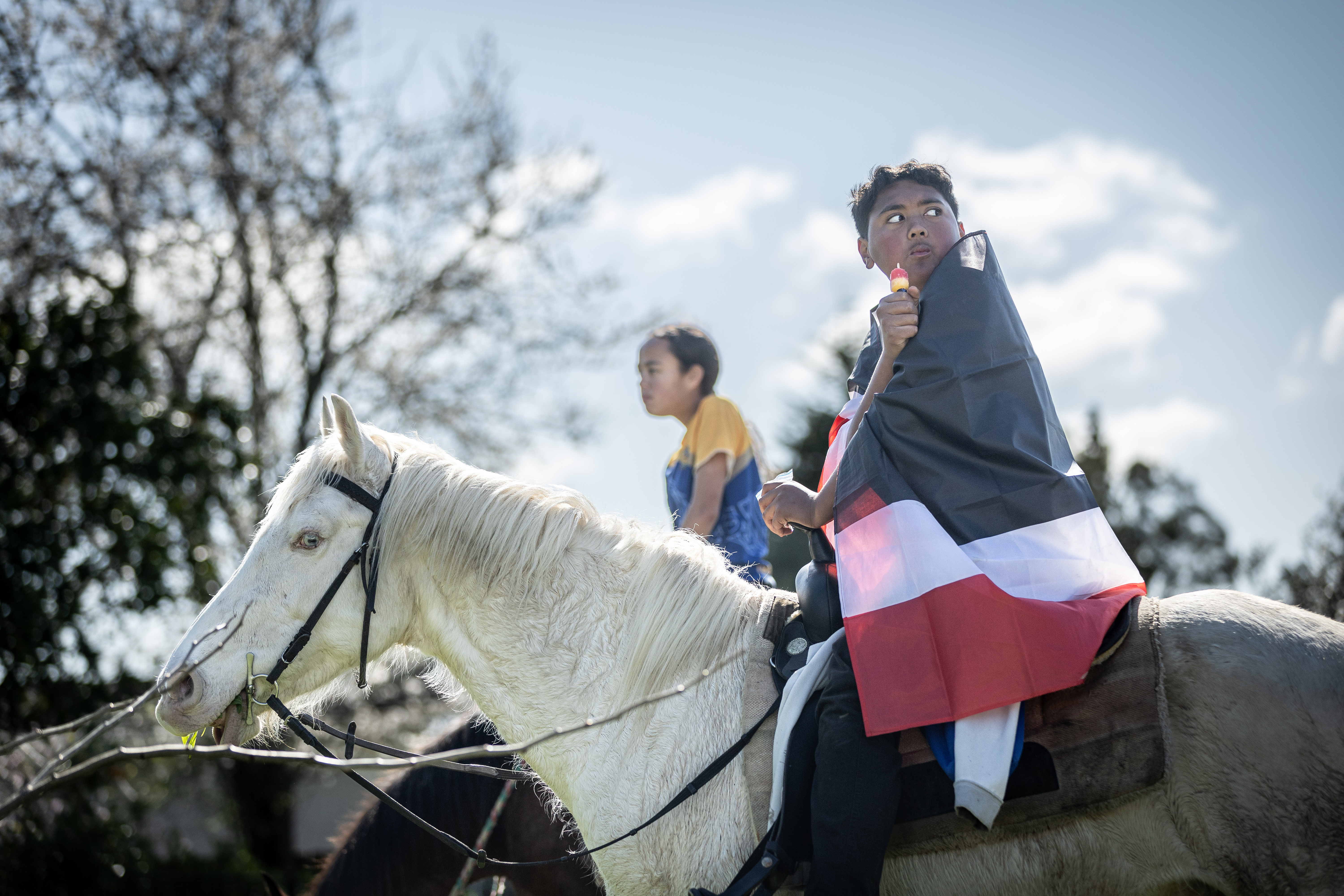 Kids ride horses in Taupiri in the hours before the casket carrying the Kīngi was due to arrive. Photo / Michael Craig