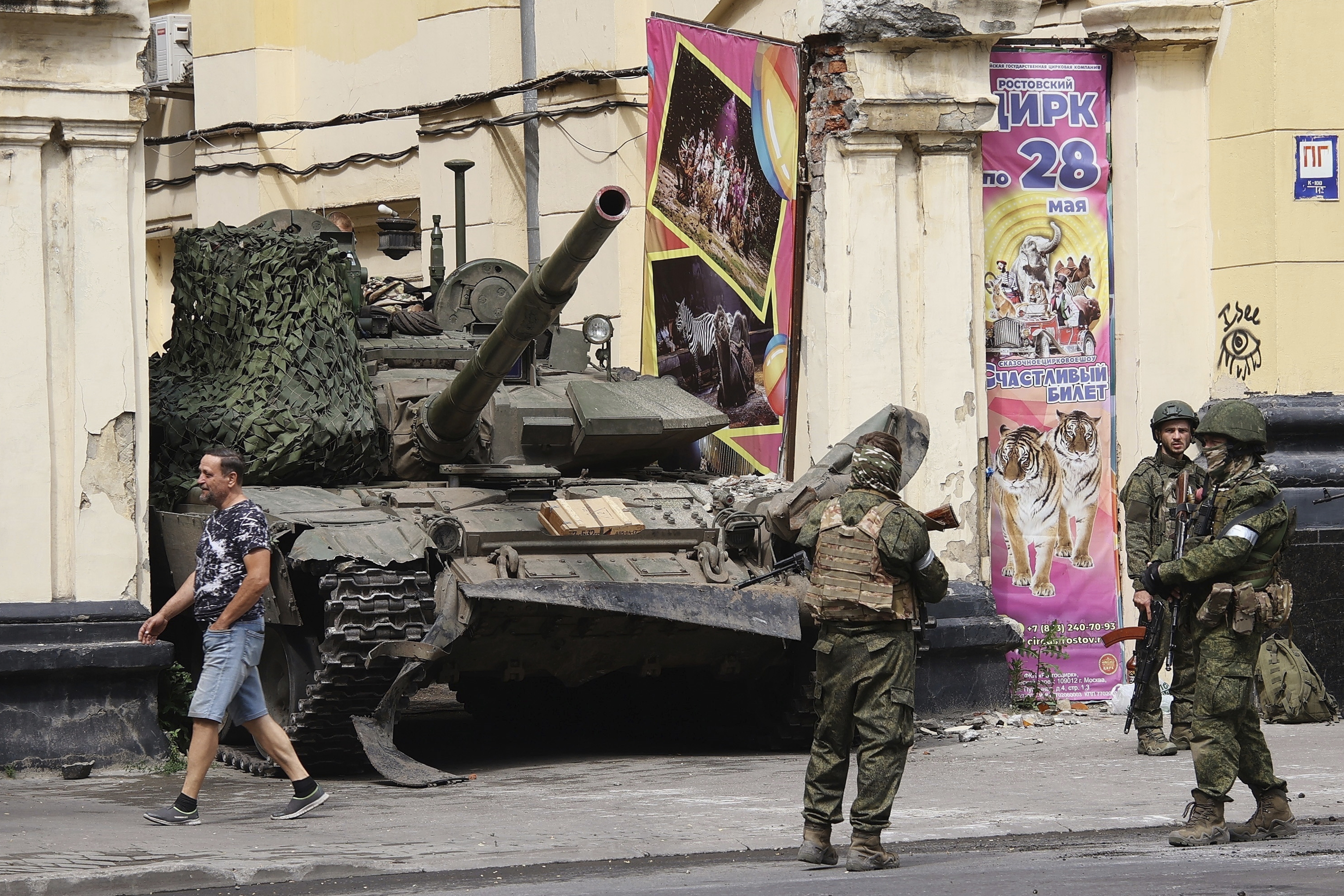 Russian servicemen guard an area standing in front of a tank in a street. Photo / AP