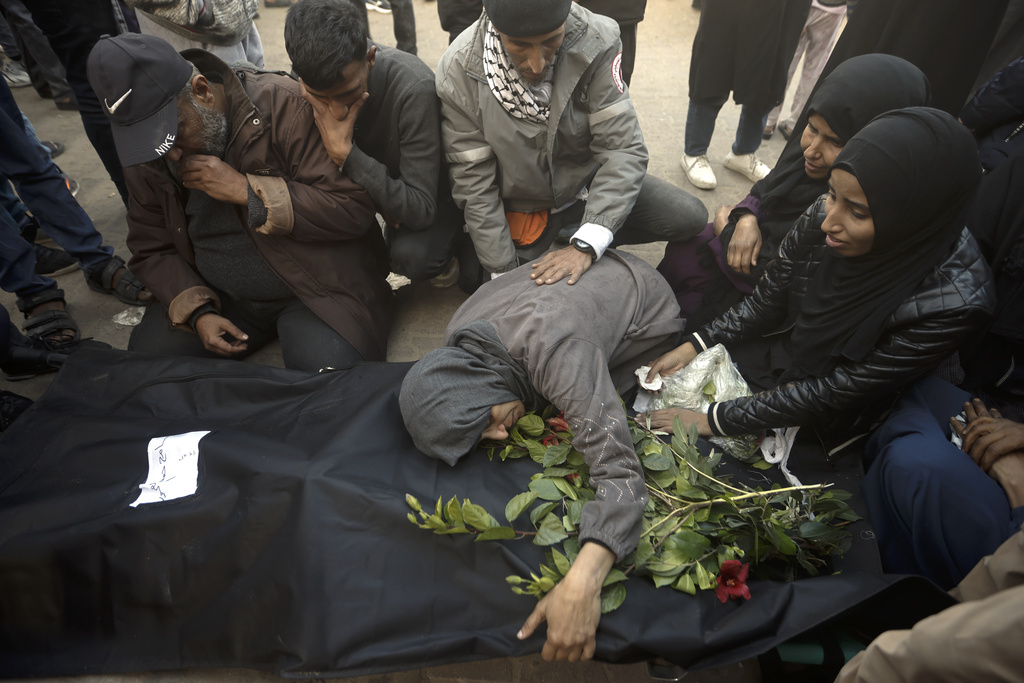 Palestinians mourn relatives killed in the Israeli bombardment of the Gaza Strip outside a morgue in Khan Younis on December 24. Photo / AP