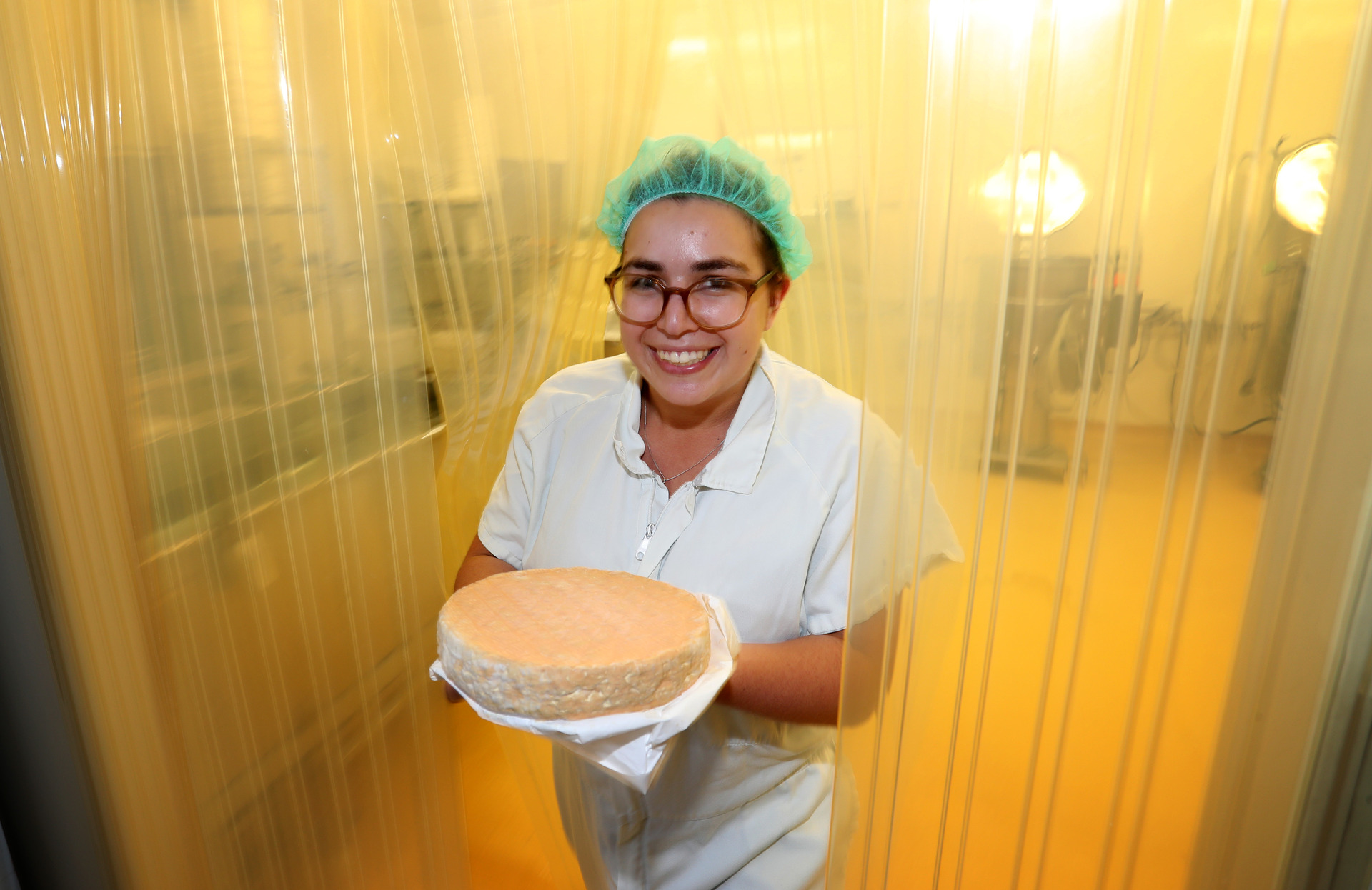 Double winner: Grinning Gecko’s Clara Perry, winner of the 2021 Aspiring Cheesemaker Award, with a round of Kau Piro (‘stinky cow’), winner of the washed-rind cheese category in the annual Champions of Cheese competition. Photo / Michael Cunningham