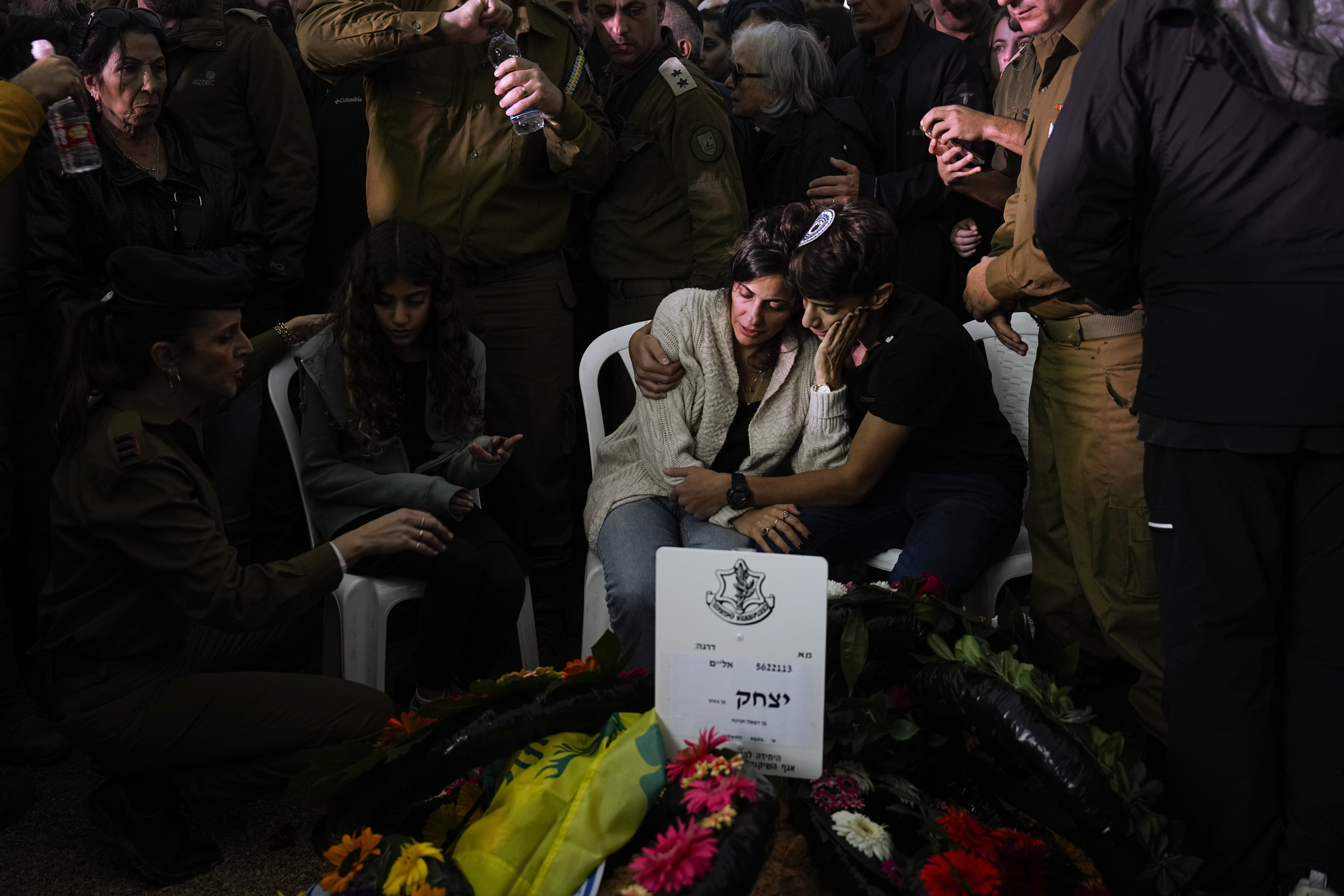 Family and friends of Israeli soldier Col. Itzhak Ben Basat mourn over his grave during his funeral in Kfar Tavor, Israel. Photo / AP