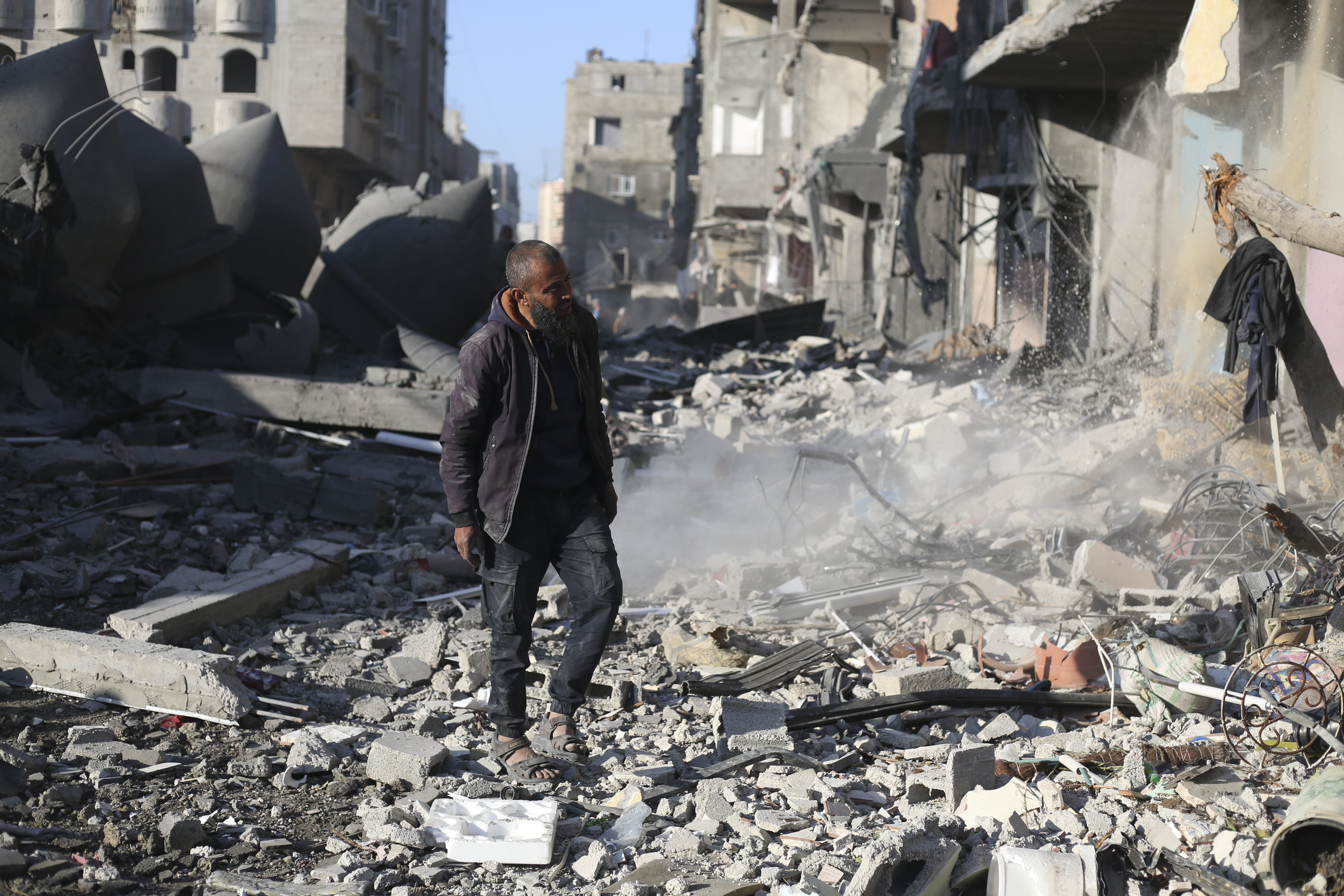 A Palestinian looks at the destruction after an Israeli strike on residential buildings in Rafah, Gaza Strip. Photo / AP