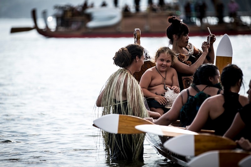 Waka arrive at Te Tii Bay. Photo / Michael Craig 