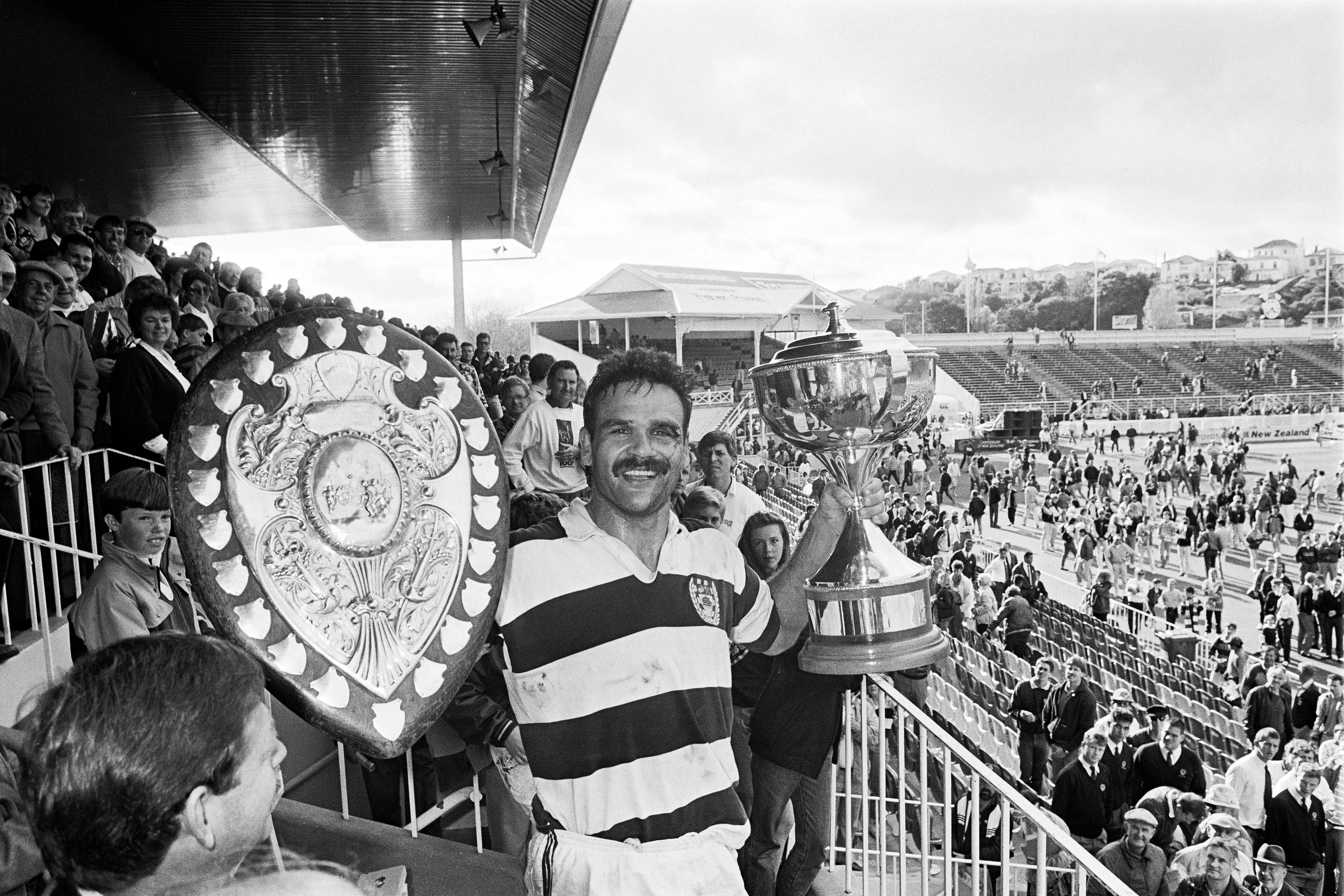 Gary Whetton lifts both the Ranfurly Shield and the NPC championship trophy after the 1988 NPC final at Eden Park. Photo / Photosport