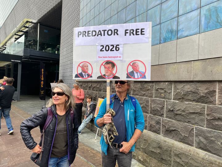 Paddy and Siri from Auckland's North Shore with their homemade sign. Photo / George Block