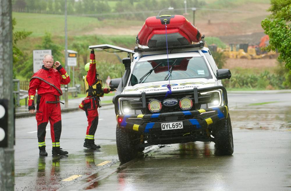 A search and rescue team pictured near the intersection of Falls Rd and Mansel Drive, Warkworth, after a man and his vehicle were washed away on Wednesday morning. Photo / Jason Dorday