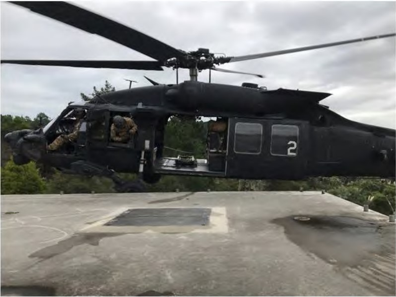 A US Army Black Hawk helicopter carrying out a one-wheel 'bump' against the roof of the NZSAS training house which Lance Corporal Nik Kahotea was trying to reach when he fell and died. 