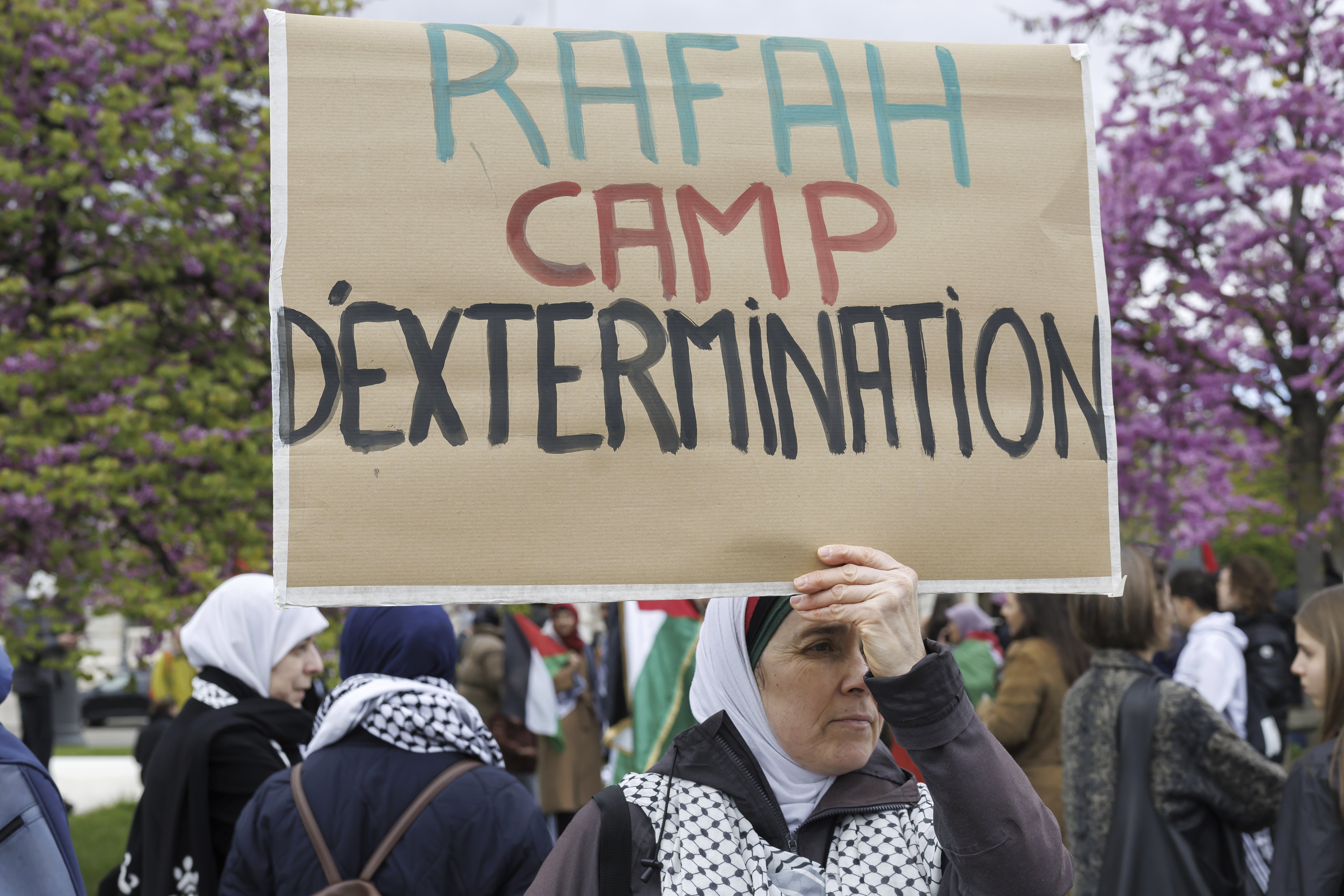 A pro-Palestinian demonstrator holds a banner reading Rafah extermination camp at a protest in Geneva, Switzerland. Photo / Keystone via AP