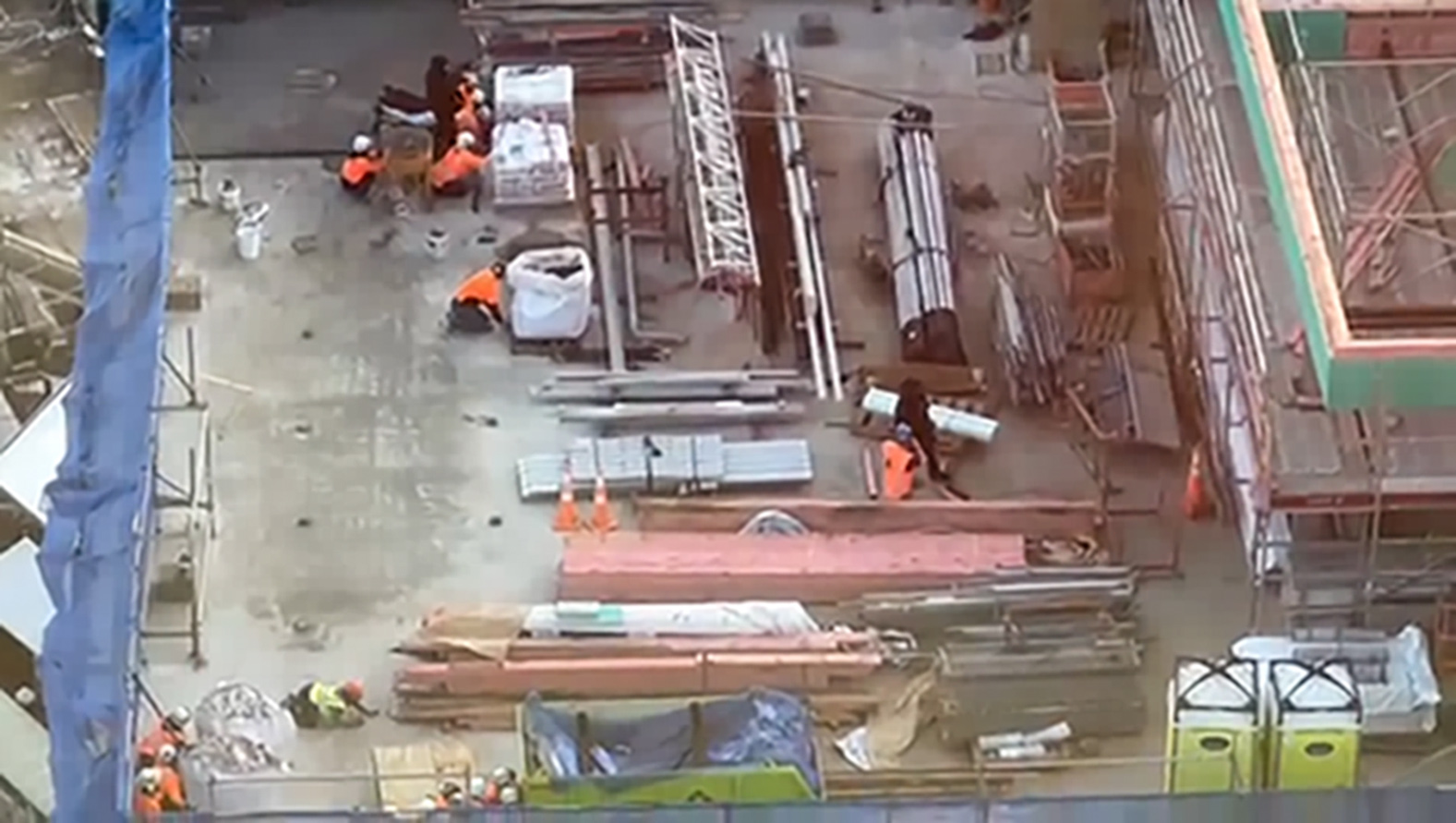 The Police Armed Offenders Squad and construction workers on the roof of the building in downtown Auckland as the shooting incident unfolded.