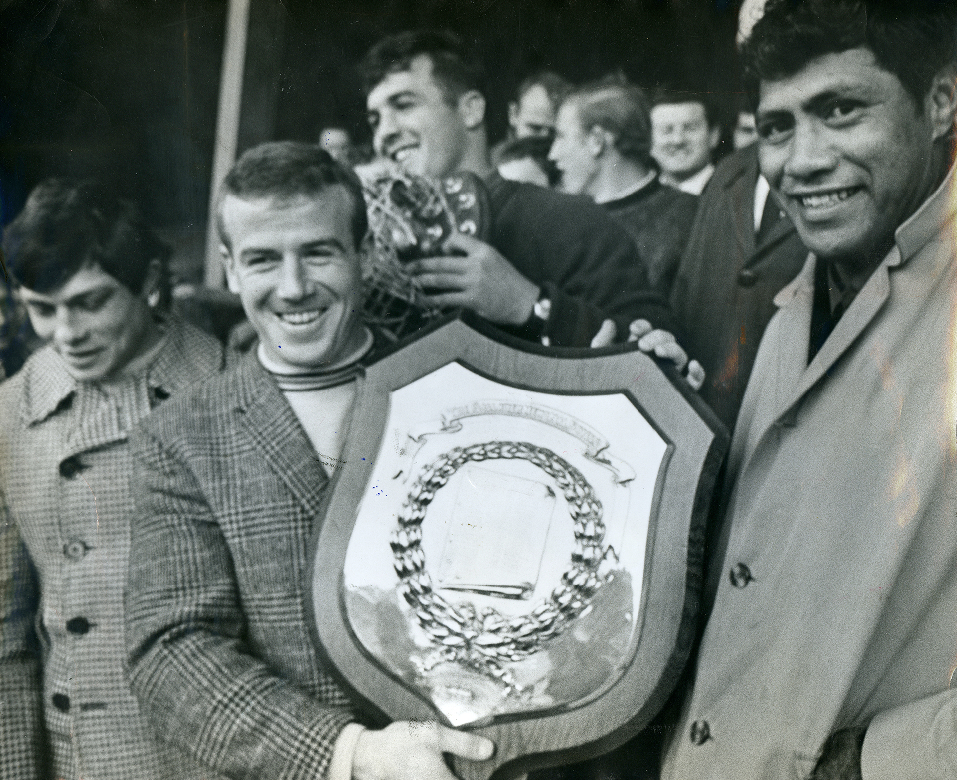 P. H. Murdoch, the Otahuhu skipper, and W. J. Nathan, the captain for the day in his last club game, surround the Gallaher Shield in 1969. Photo / File