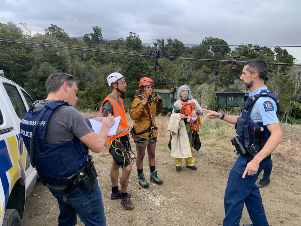 350 Aotearoa protesters being arrested on the Denniston Plateau. Adam Currie is on the left.