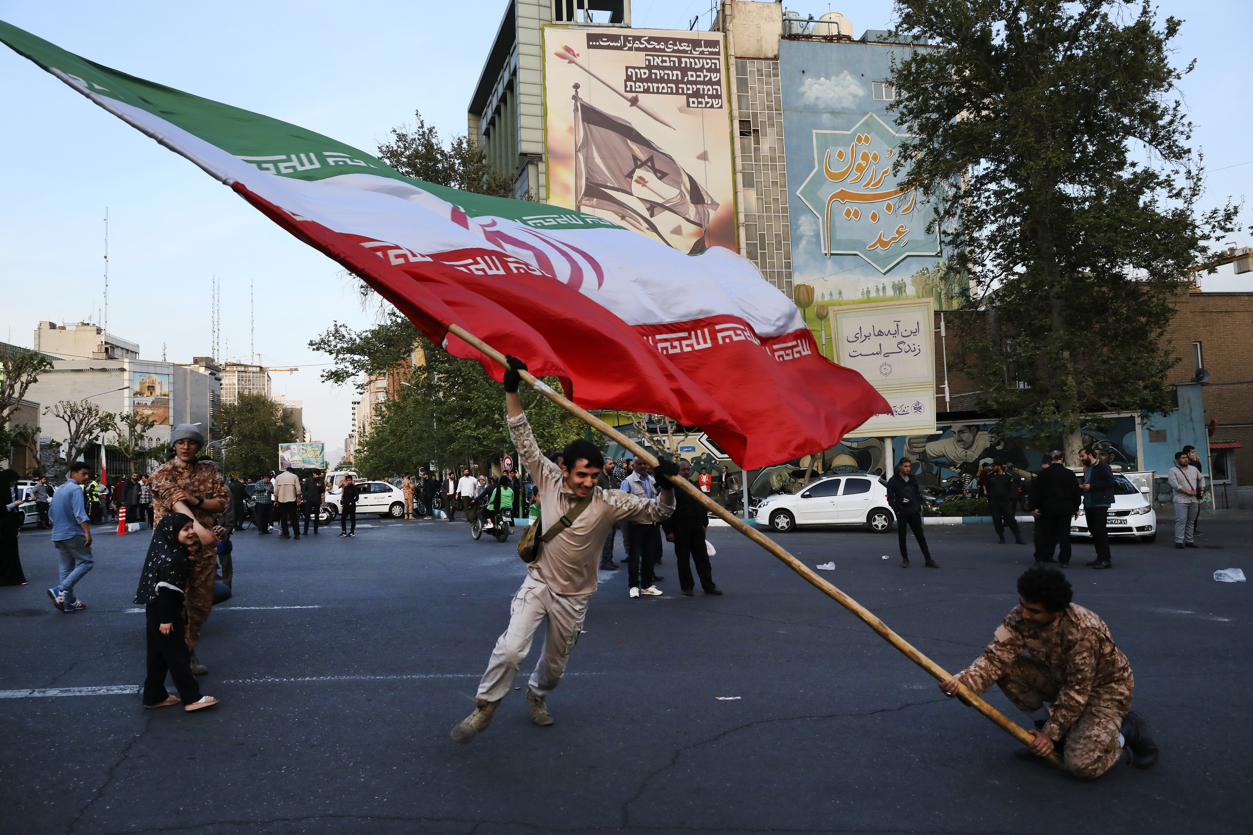 Demonstrators wave a huge Iranian flag in an anti-Israeli protest. Photo / AP