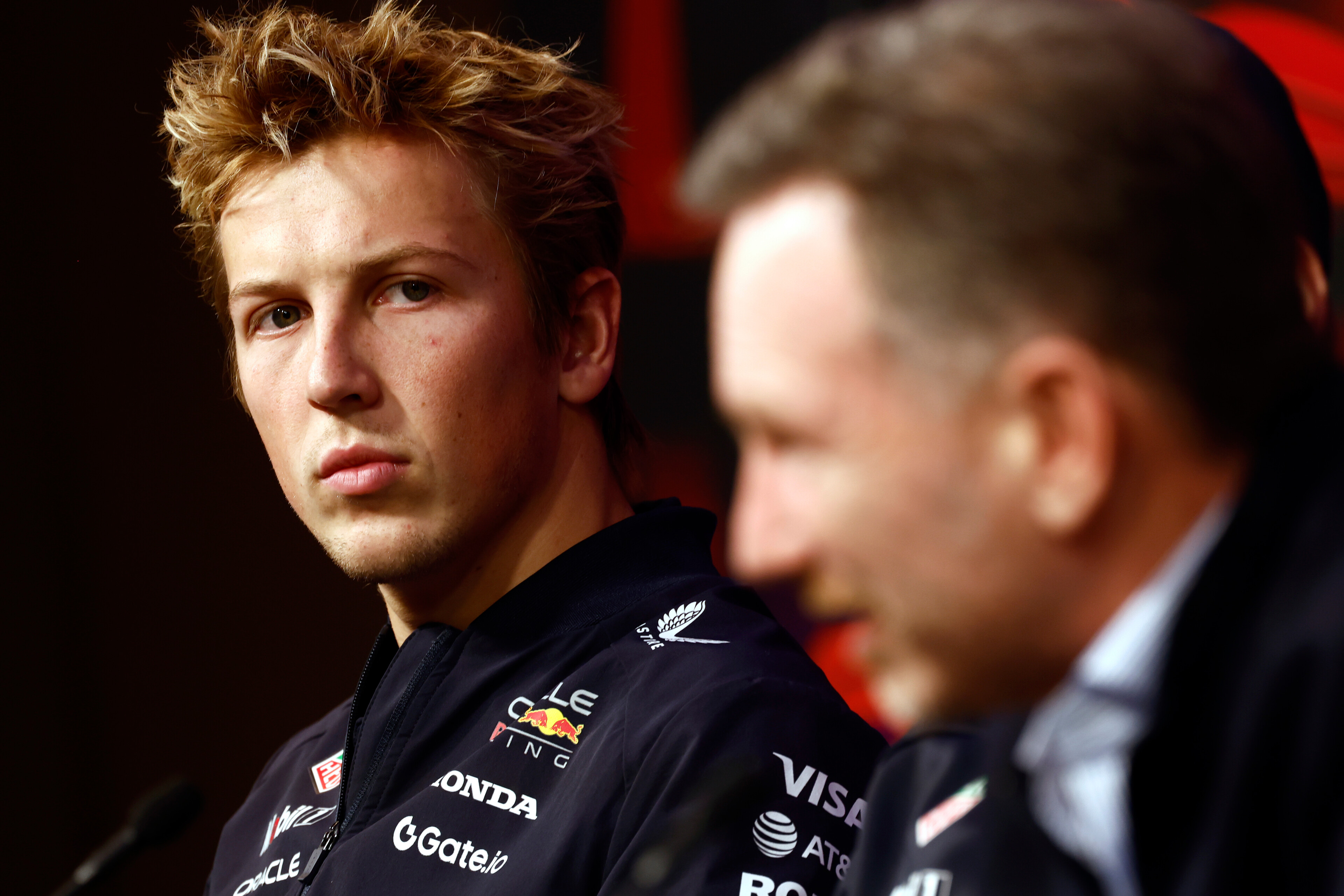 Formula One driver Liam Lawson looks on during a press conference last year as Christian Horner, who was later sacked by Red Bull, speaks. Photo / Red Bull
