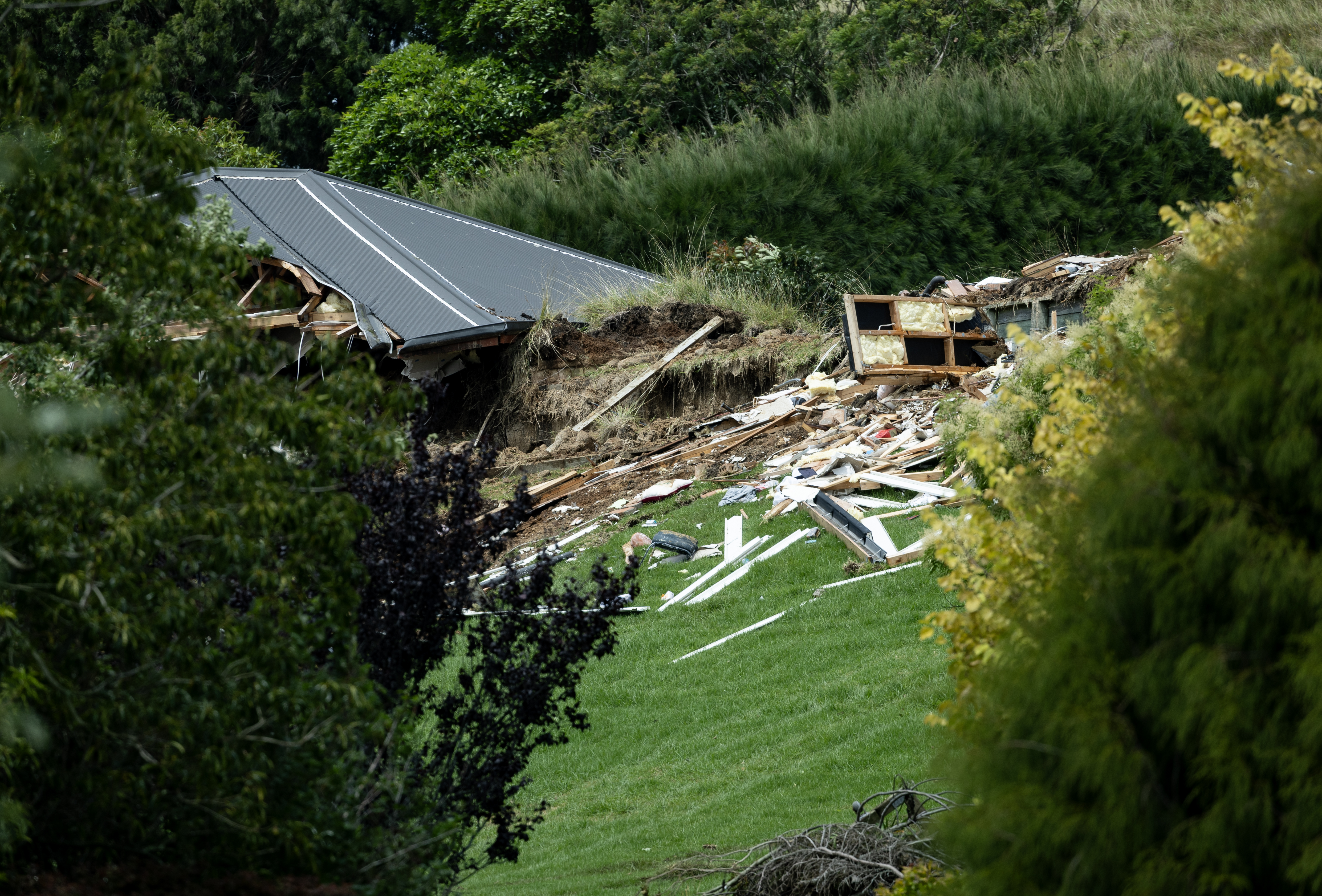 One of the homes destroyed in a landslide that killed a grandmother and grandson on Welcome Bay Rd. Photo / Dean Purcell