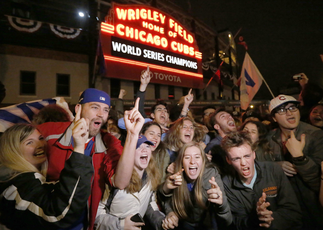 Chicago Cubs fans celebrate in front of Wrigley Field in Chicago. Photo / AP