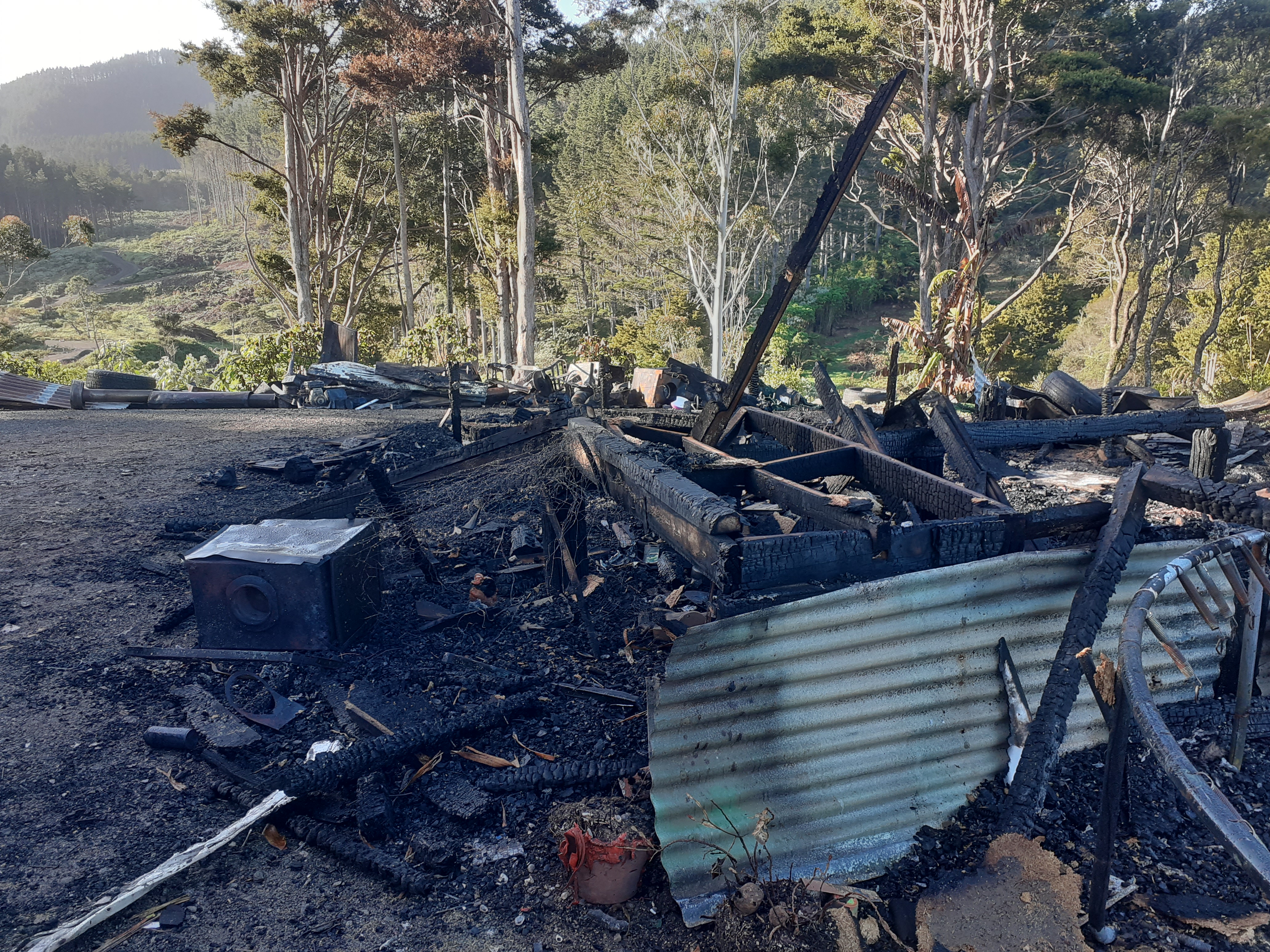 Golf clubs and some school bags was all James O'Neil was able to grab from his family home before it was destroyed by fire on August 11.