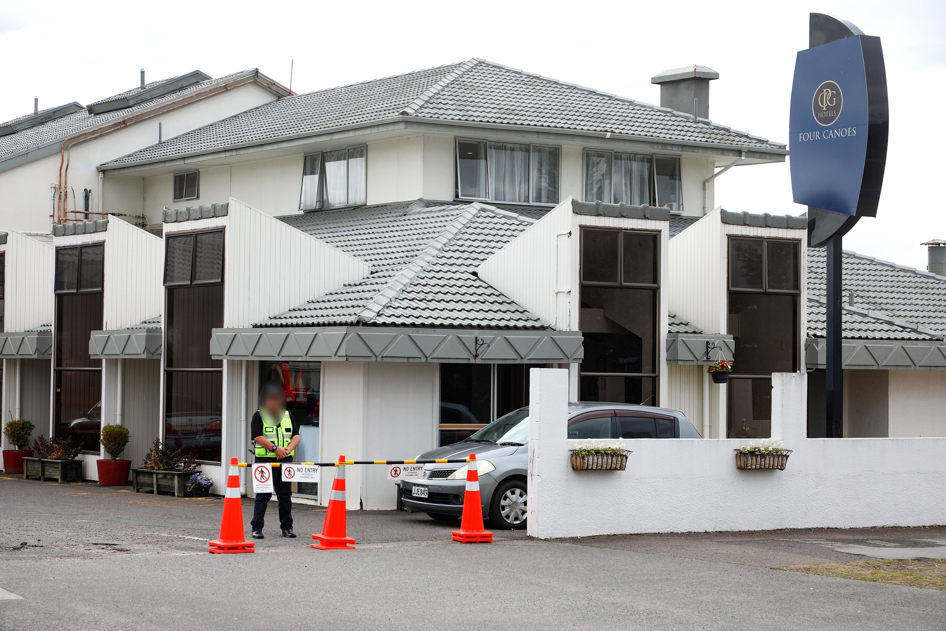 A security guard outside the Four Canoes Hotel on Fenton St. Photo / Andrew Warner
