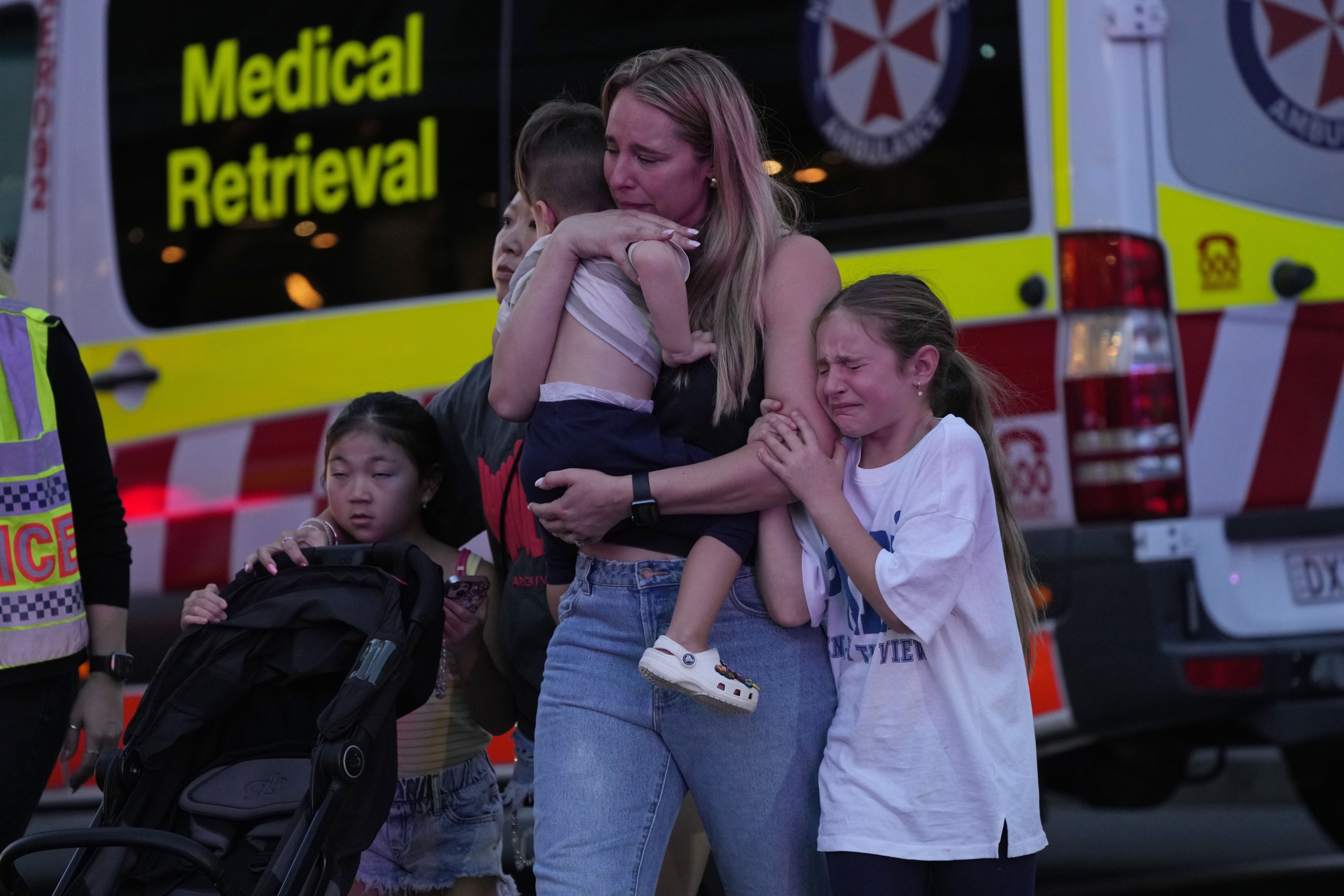 People were led out from the Westfield Shopping Centre where multiple people were stabbed in Sydney on Saturday. Photo / AP