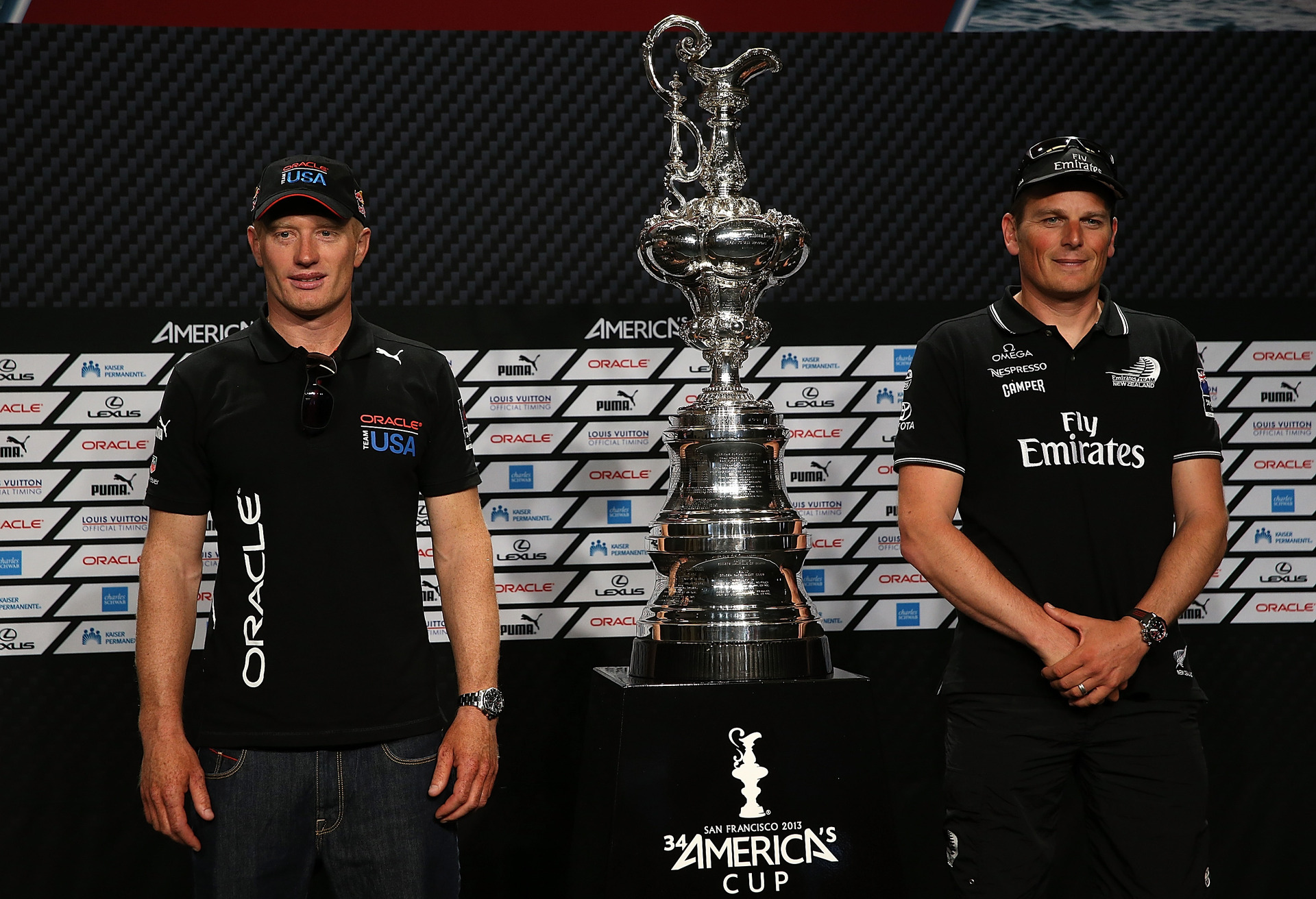 Emirates Team New Zealand skipper Dean Barker (R) and Oracle Team USA skipper James Spithill (L) stand with the America's Cup trophy. Photo / Getty Images.