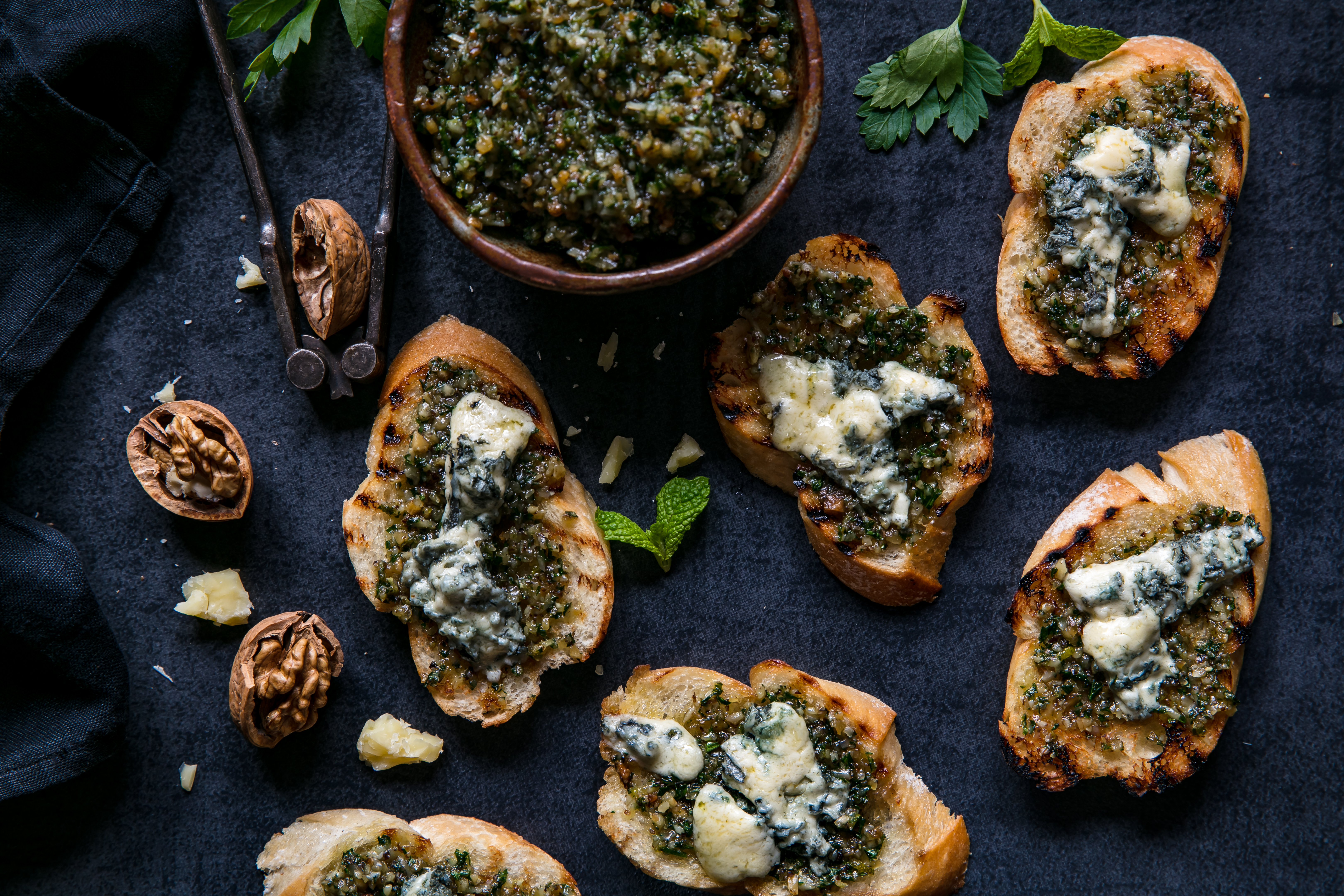 Walnut and parsley pesto is a delicious alternative to the traditional Genovese version, served here on bruschetta with blue cheese. Photo / Babiche Martens