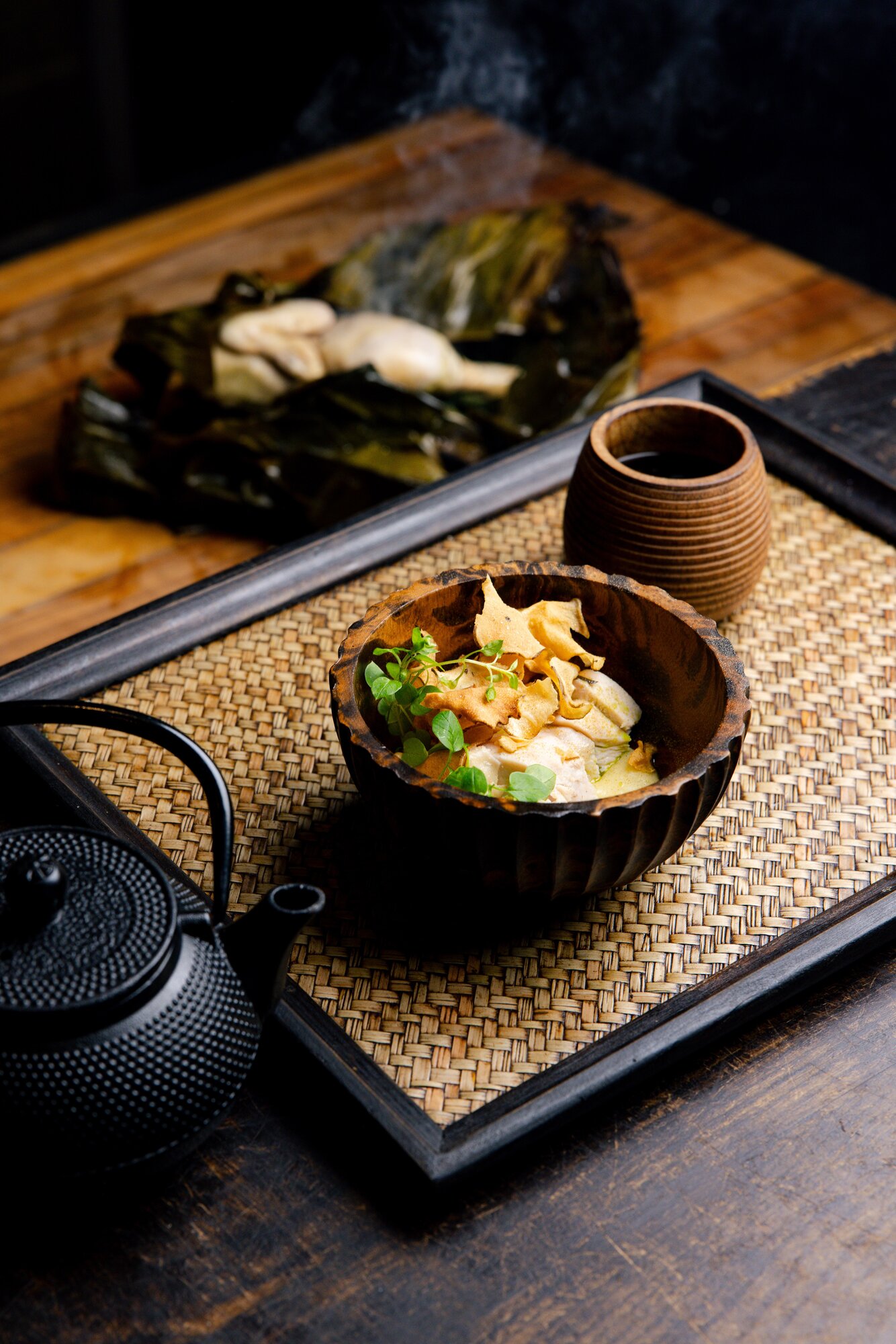 Tala's signature umu chicken - hot stones are placed inside a brined and banana leaf stuffed and wrapped chicken - with a warm chicken and coconut broth. 