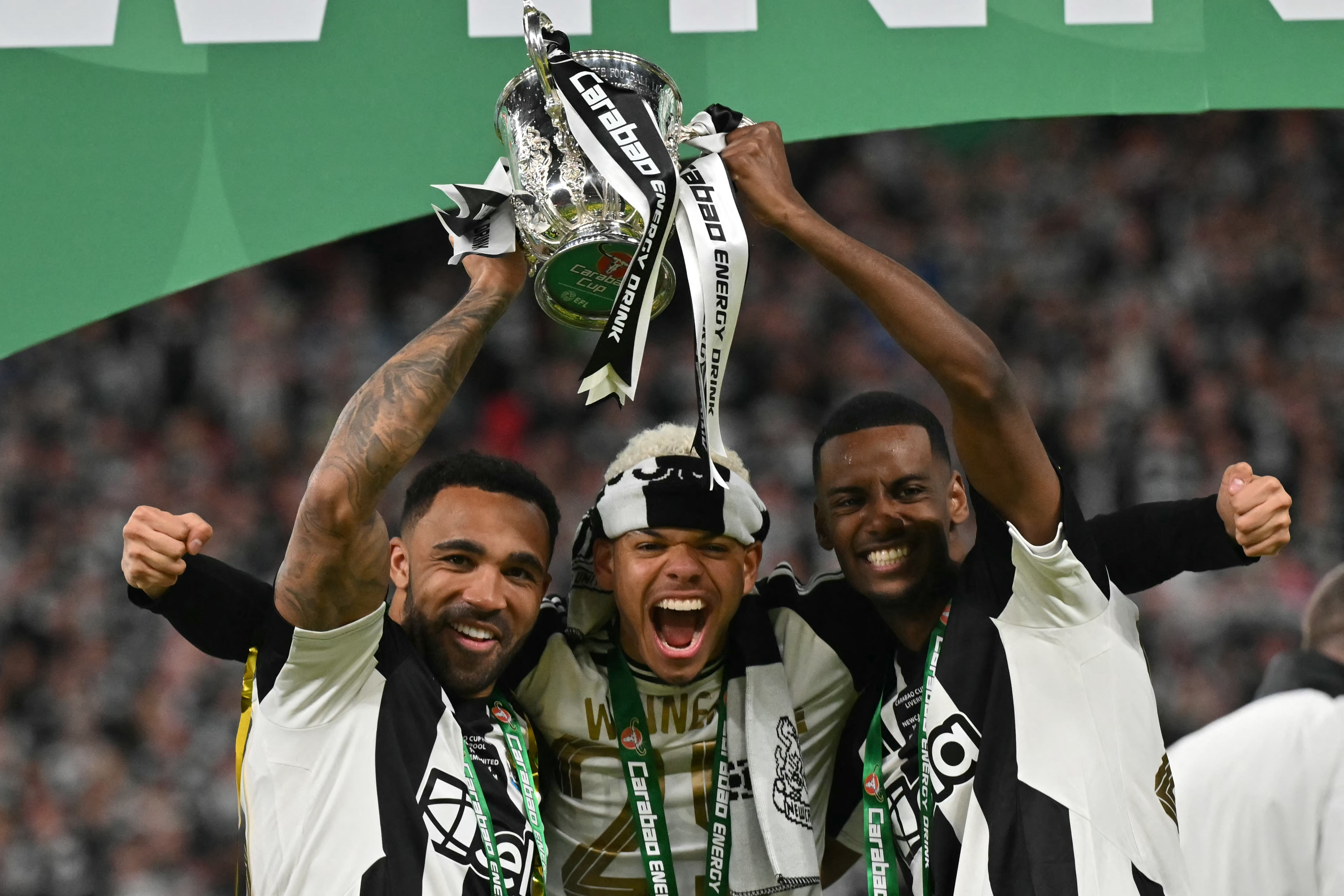 Newcastle United's Callum Wilson, William Osula and Alexander Isak celebrate with the trophy after winning the English League Cup final. Photo / AFP