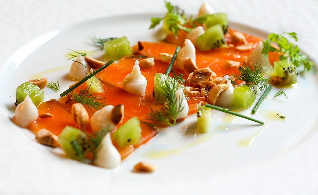 Vanilla & citrus dried Ora King salmon finished with the local cognac, with kiwi fruit, coconut and hazelnuts at Le Petit Leon. Picture / Supplied.