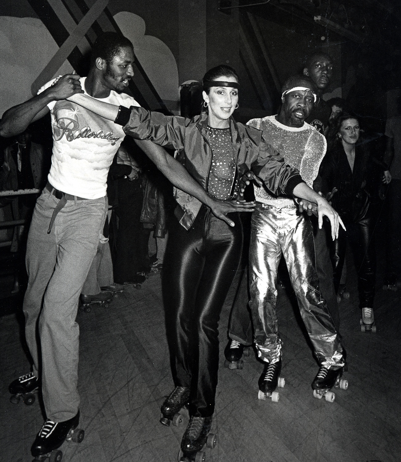 Cher skates with Bill Butler (right) at the Empire Roller Disco in 1979. Photo / Getty Images