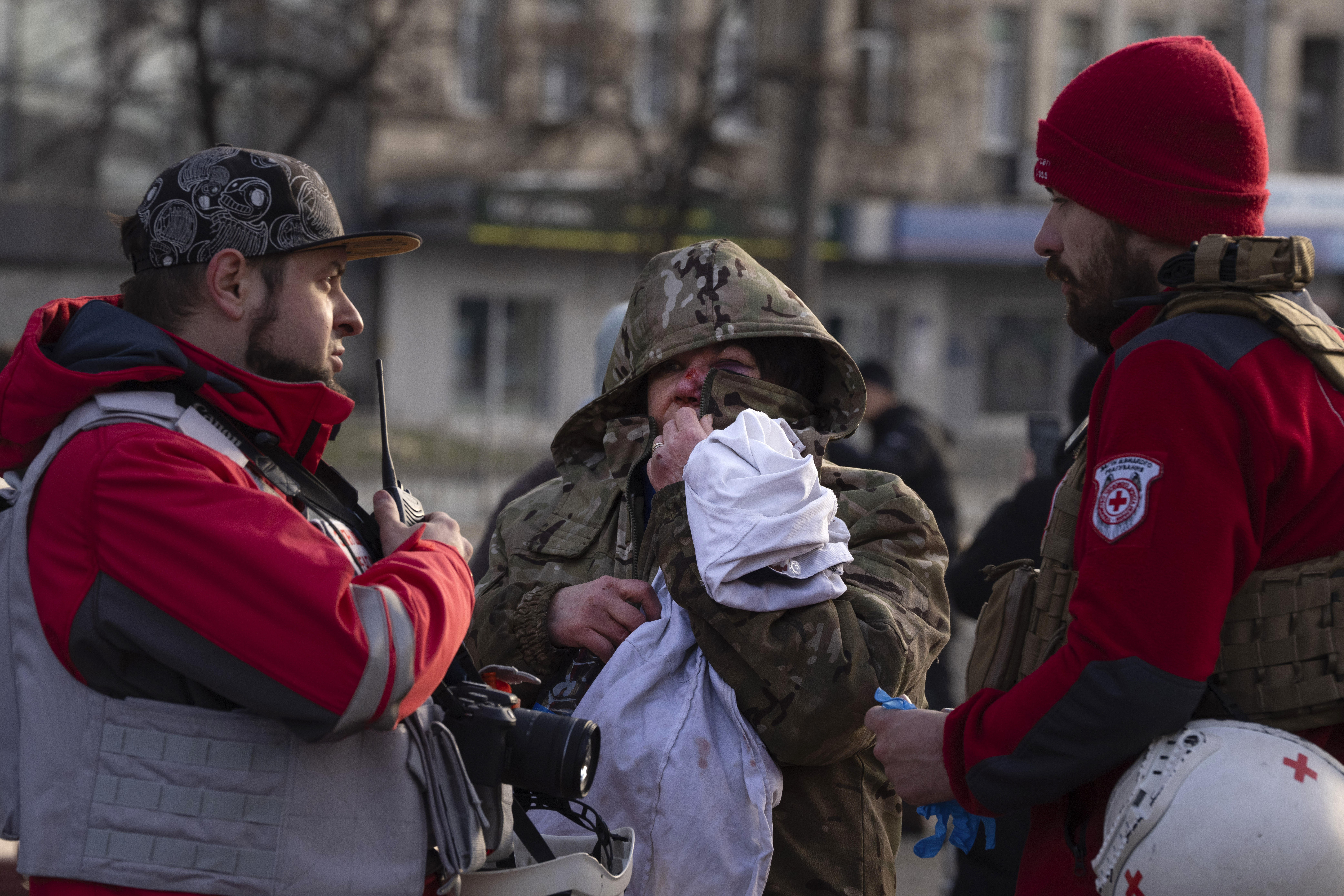 A wounded resident talks with paramedics after Russia's missile attack in Kyiv, Ukraine. Photo / AP