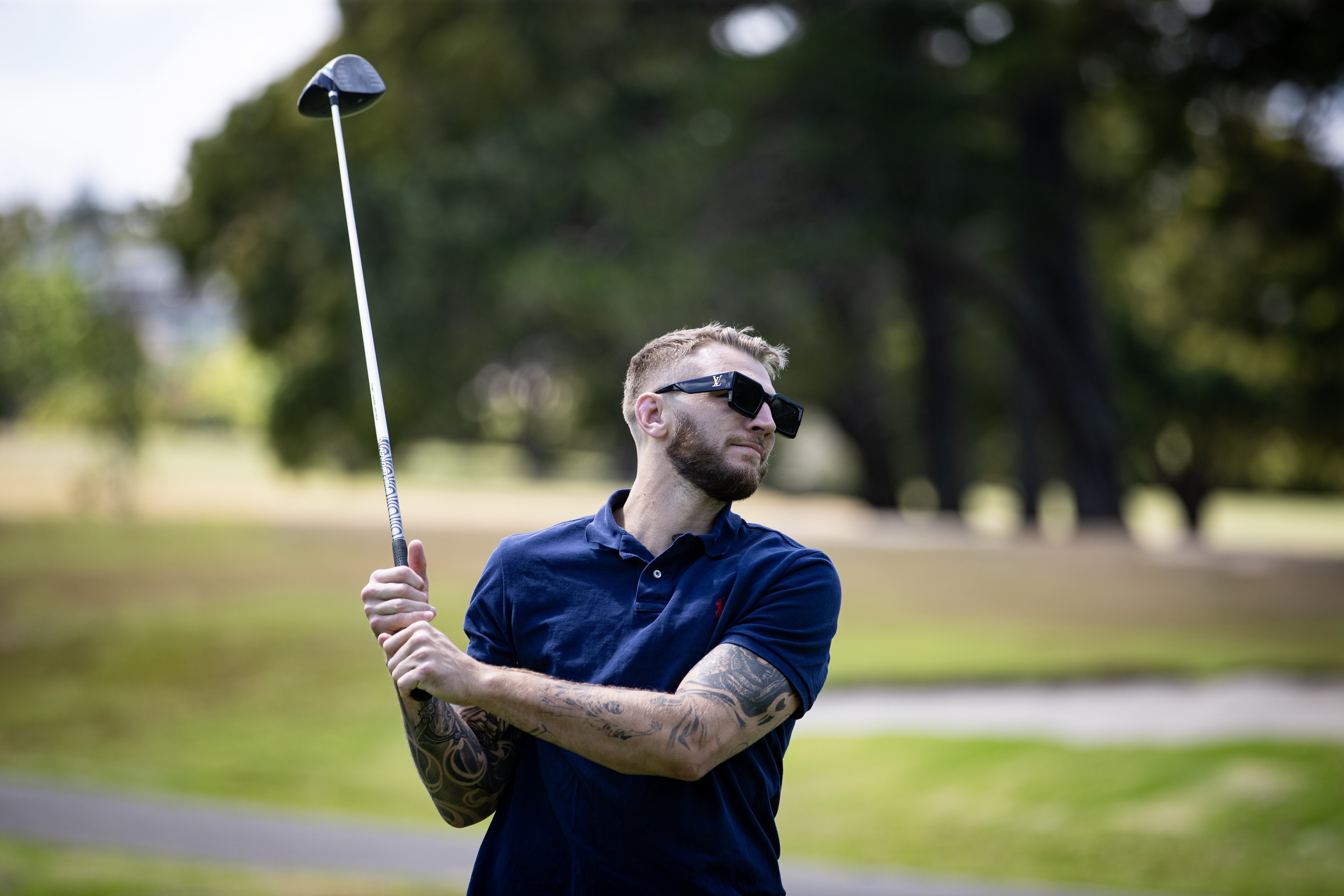 Dan Hooker admires his shot during a round at Maungakiekie Golf Club. Photo / Dean Purcell