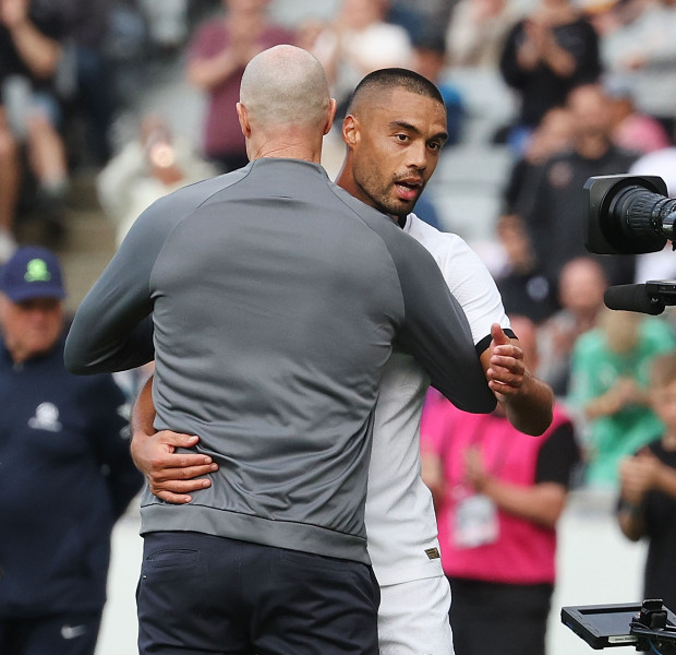 Coach Danny Hay (L) embraces Winston Reid after the fulltime whistle is blown at Eden Park. Photo / Photosport