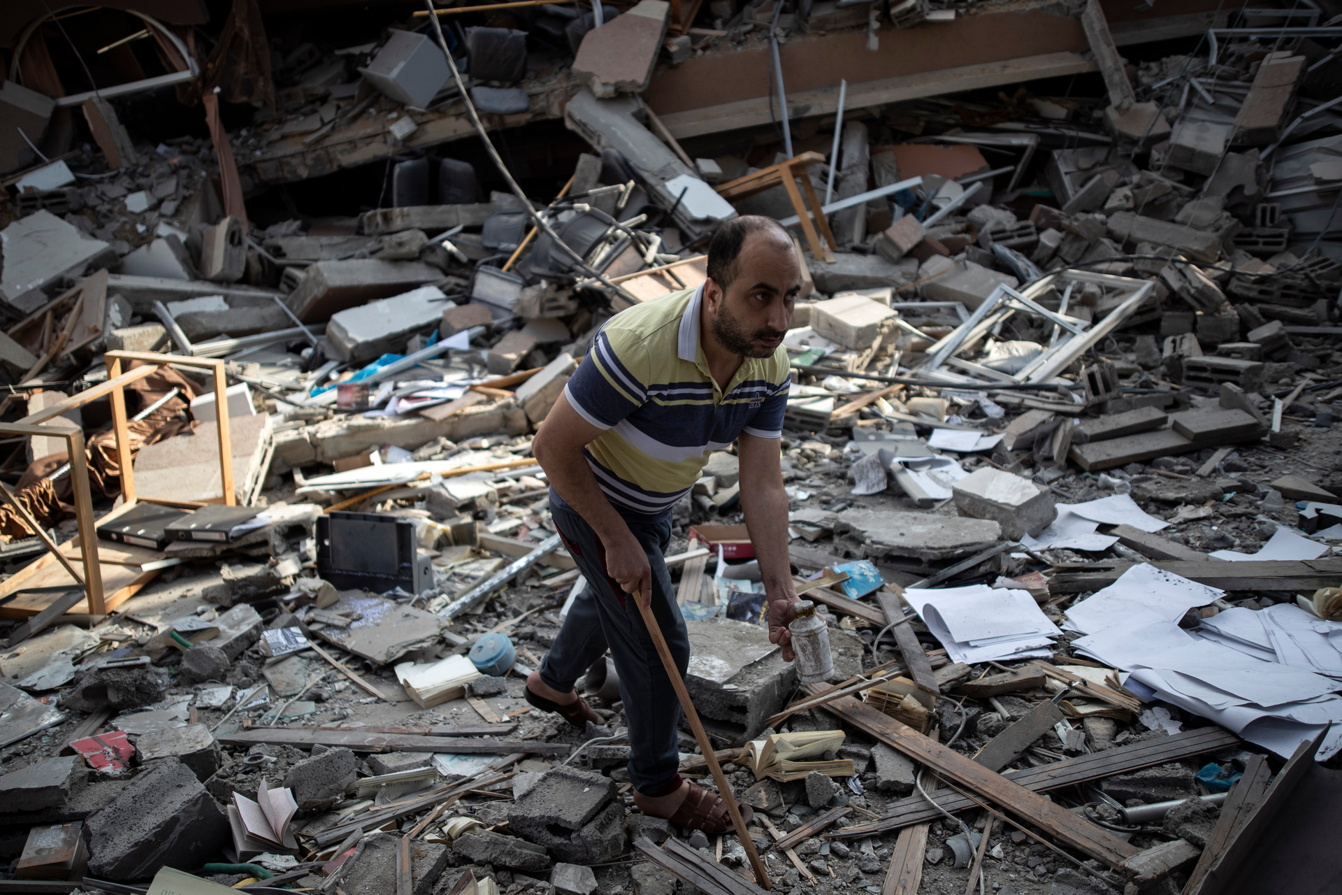 A Palestinian man inspects the damage of a house destroyed by an early morning Israeli airstrike, in Gaza City. Photo / AP
