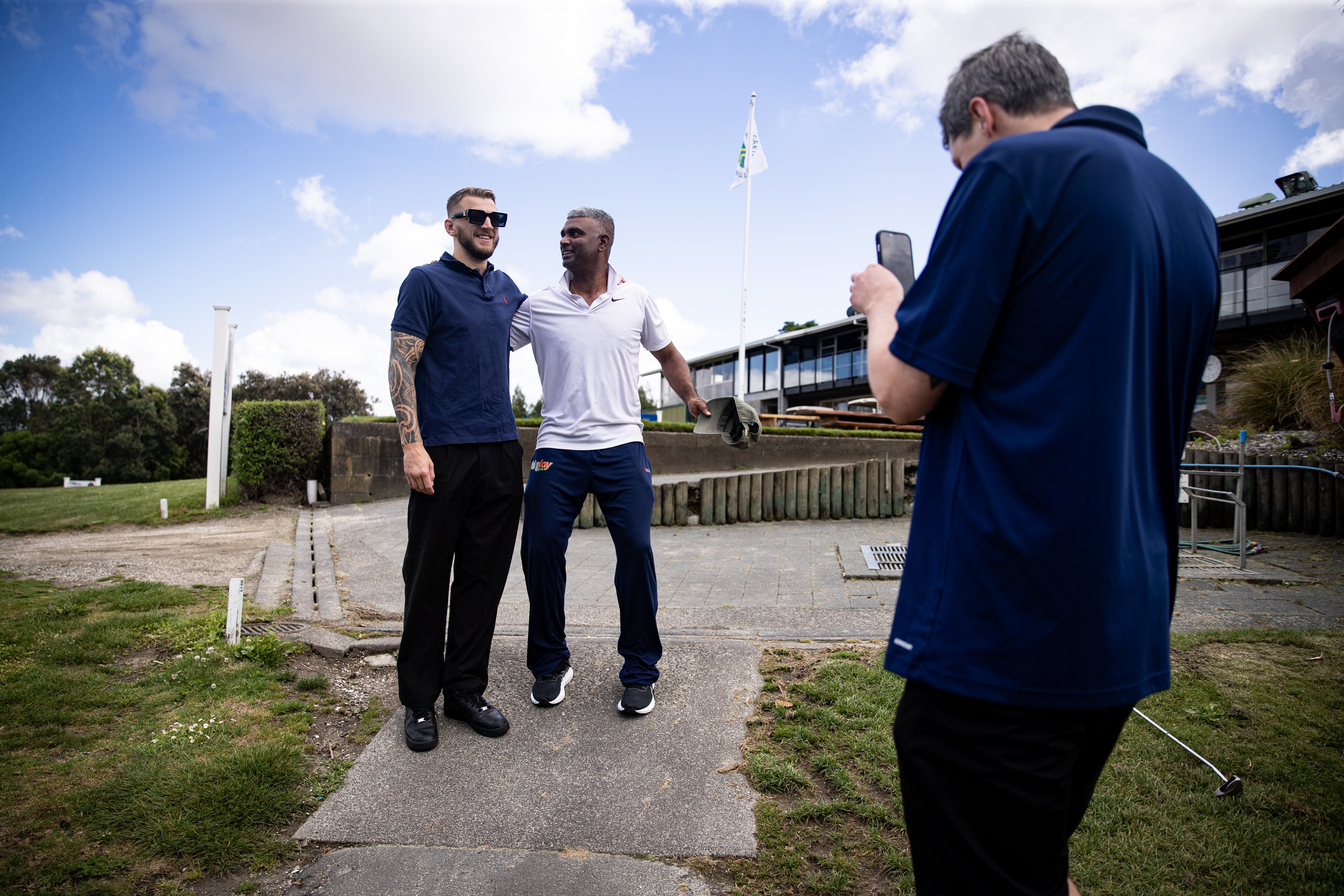 Dan Hooker poses for a photo with a fan at Maungakiekie Golf Club. Photo / Dean Purcell