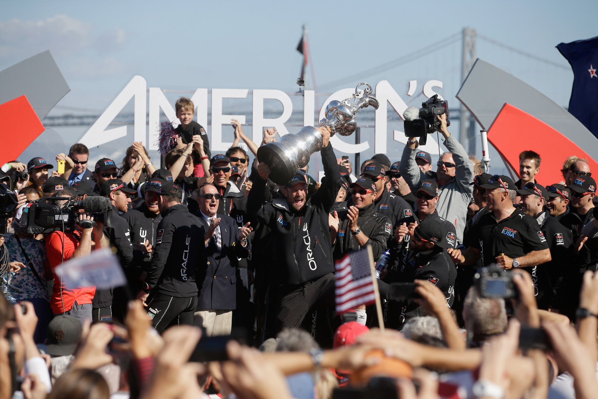 Oracle Team USA celebrates with the America's Cup trophy after they beat Emirates Team New Zealand skippered by Dean Barker in race 19 to win the America's Cup Final. Photo / Getty.