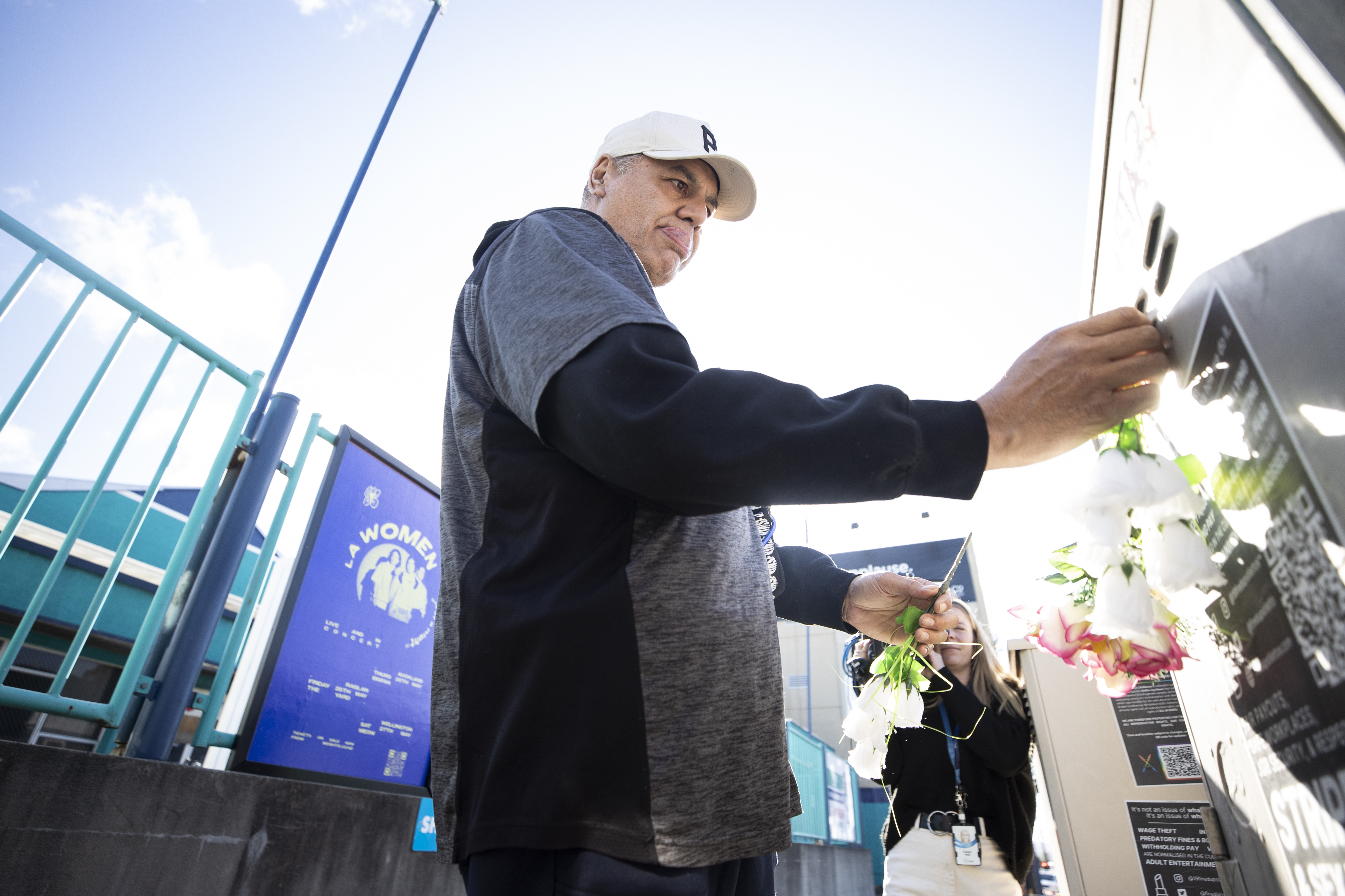 Loafers Lodge arson survivor Chris lays flowers as a sign of respect for those who lost their lives. Photo / George Heard